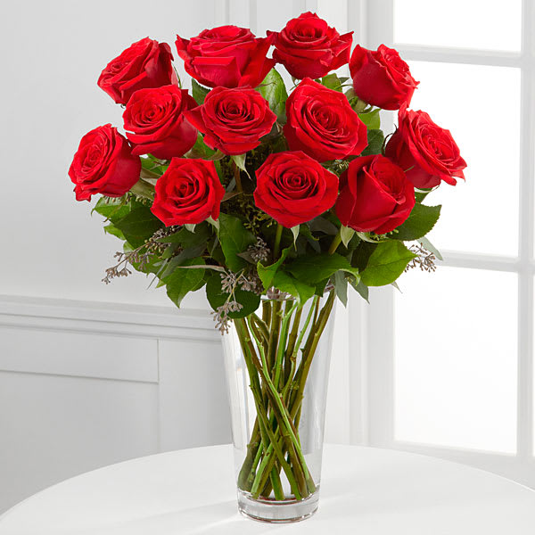 The FTD Red Rose Bouquet - Nothing speaks of love so much as a bouquet of 12 beautiful long stem red roses. Arranged with seeded eucalyptus in a classic glass vase this bouquet is a gift to her heart from yours. 