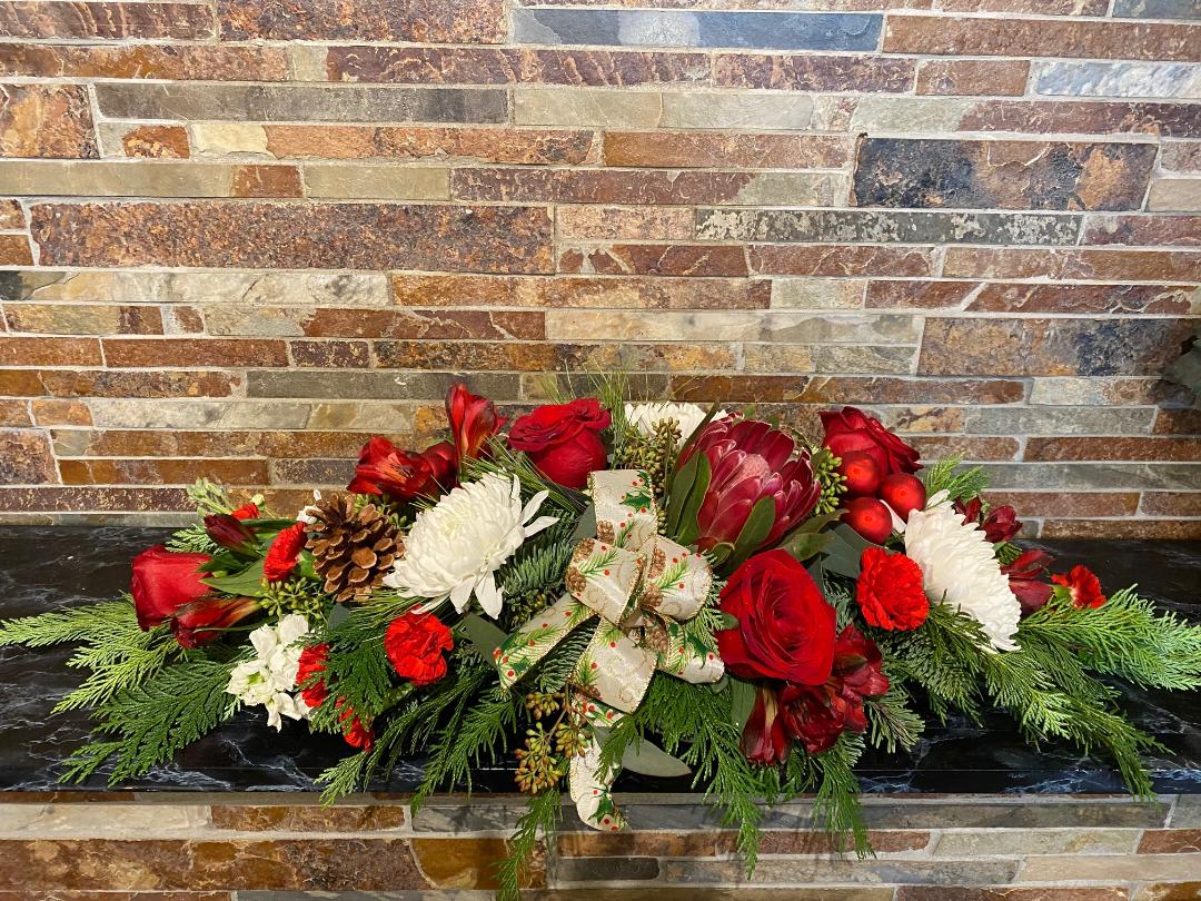 Elegant Christmas Eve - This is your classic "long and low" centerpiece. The perfect way to finish off and add whimsy to your holiday table setting. It's all about the flowers in this design, including roses, mums, and other holiday accents! (Can be customizable- add details in special instructions!