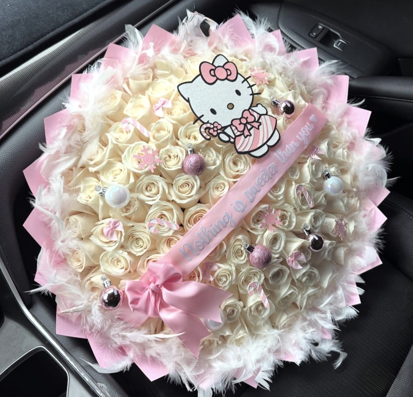 Hello kitty Christmas cotton candy bouquet  - Charming and magical bouquet of 75 white roses with pink Christmas spheres, pink and white candy canes, pink snowflakes, white feather boa ribbon with printed message (personalized) wrapped in pink cotton candy paper. (plush or hello kitty print depends on availability) order today.