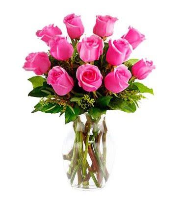 Hot Pink Rose Bouquet - Picture-perfect hot pink roses make a beautiful gift to brighten the day of the lovely lady in your life. Wife mother daughter or sweetheart she's sure to cherish this bouquet of hot pink roses arranged in a clear glass vase.
