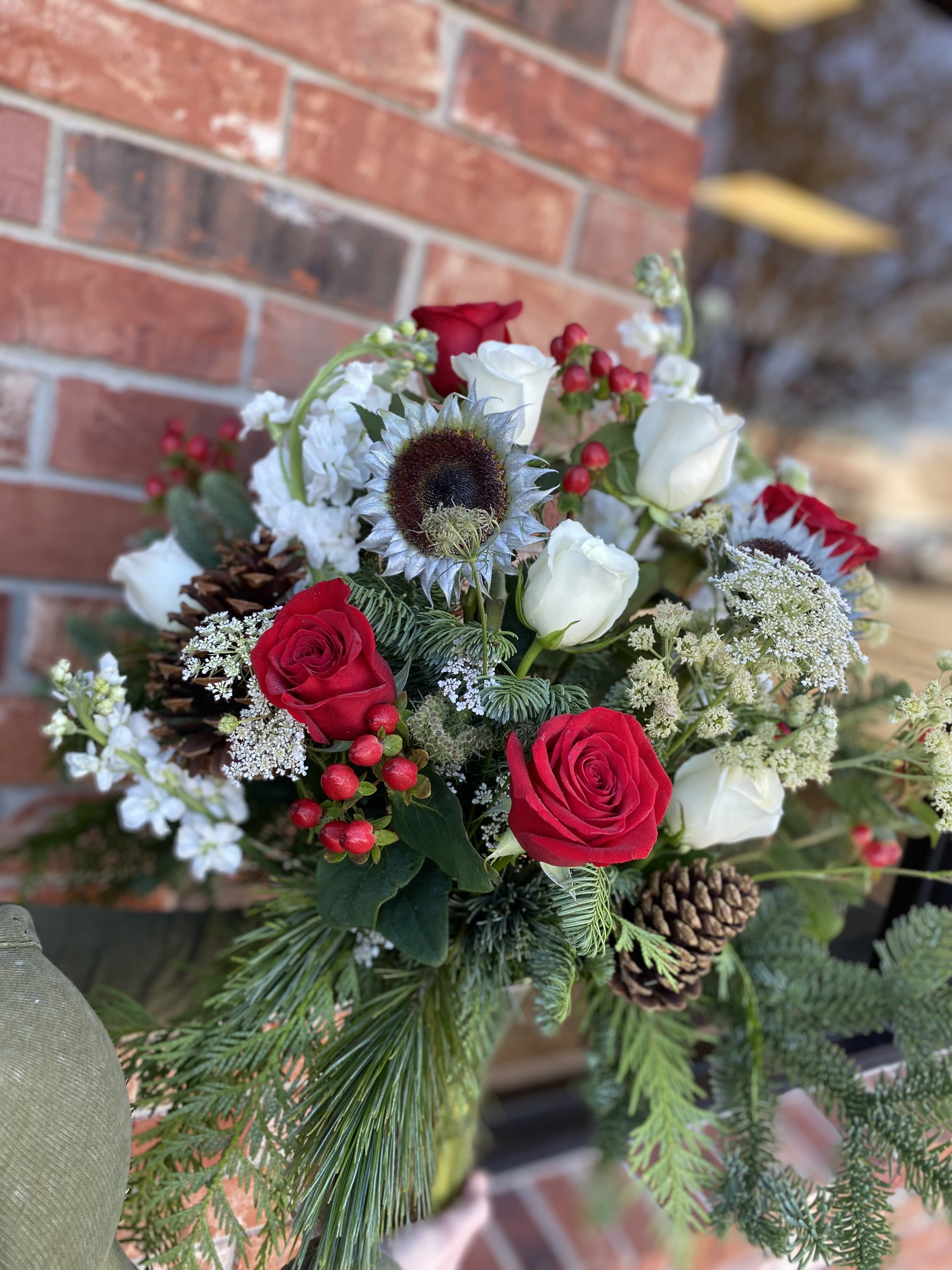 Winter wishes bouquet  - Send the magic of the season with our Winter Wishes Bouquet—a charming blend of winter elegance and festive warmth. This arrangement features a harmonious mix of seasonal blooms, lush evergreens, and delicate holiday accents that capture the beauty of a crisp winter day. Soft textures and rich colors come together to create a bouquet that feels both enchanting and comforting. Perfect for brightening someone’s home, sending holiday cheer, or adding a wintry touch
