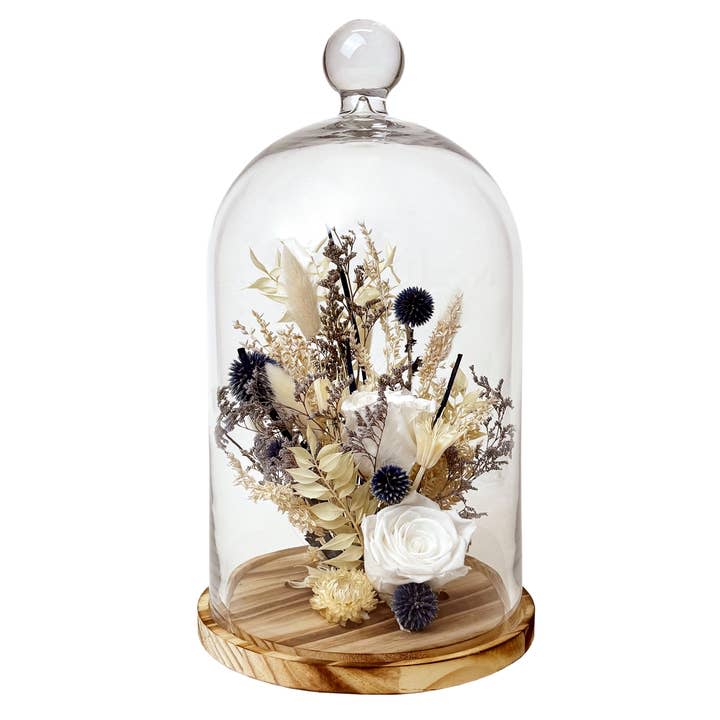 15" White Preserved Rose &amp; Echinops Botanical Cloche - A preserved real rose is arranged among a mix of natural botanicals like echinops, bunny tails, and caspia in this stunning floral arrangement placed in a large glass cloche on a wooden pedestal base.  This centerpiece is full of natural textures and neutral colors that easily accentuate any home and are sure to be a show stopper!  Each cloche comes carefully packaged &amp; boxed, ready to be gift wrapped.  