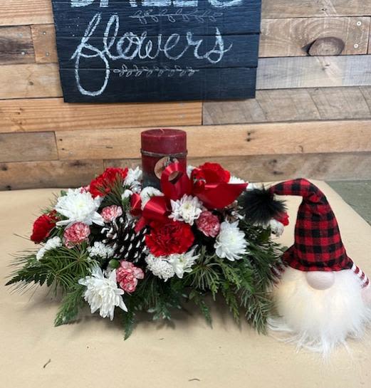 Votive Candle Centerpiece - Holiday Centerpiece arrangement which will include: Peppermint Carnations, Red Carnations, White Cushions, Pine Cones, Mini Carnations, 1 Votive Candle placed in the middle, Assorted Winter Greenery.  **Gnome NOT Included**
