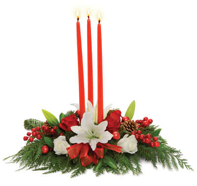 Trinity Candle Centerpiece - A trio of red taper candles hover above the perfect holiday centerpiece of white lilies, red roses, holiday trim, berries and pine boughs.