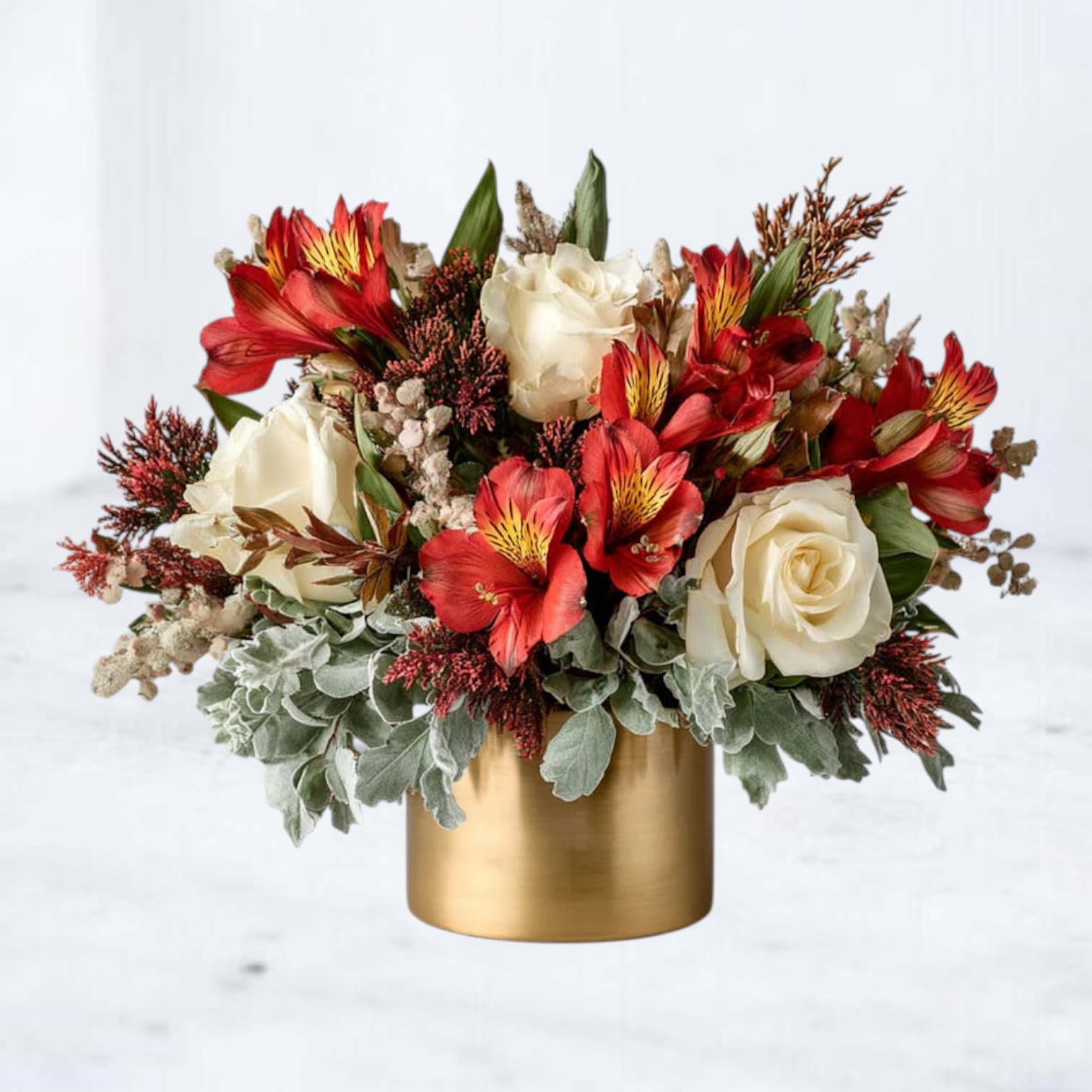 Burnished Glow Bouquet - Bring the glow of the season indoors with our Burnished Glow Bouquet, a striking fall bouquet arranged in a chic gold vase. Featuring rich red alstroemeria, creamy roses, seasonal foliage, and warm autumn accents, this design radiates elegance and warmth. Perfect for birthdays, holiday gatherings, or simply brightening the home, this arrangement is a stunning way to celebrate the beauty of autumn.  Now available for same-day holiday flower delivery in Galveston, Jamaica Beach, Tiki Island, Sea Isle, Hitchcock, La Marque, Santa Fe, Texas City, League City, Dickinson, Kemah, Clear Lake, Webster, and surrounding coastal communities along Galveston Bay.  Substitution Disclaimer Due to seasonal availability, some blooms or accents may be replaced with similar premium varieties of equal or greater value to maintain the design’s look and integrity. Your arrangement will always reflect the same spirit, palette, and premium quality.