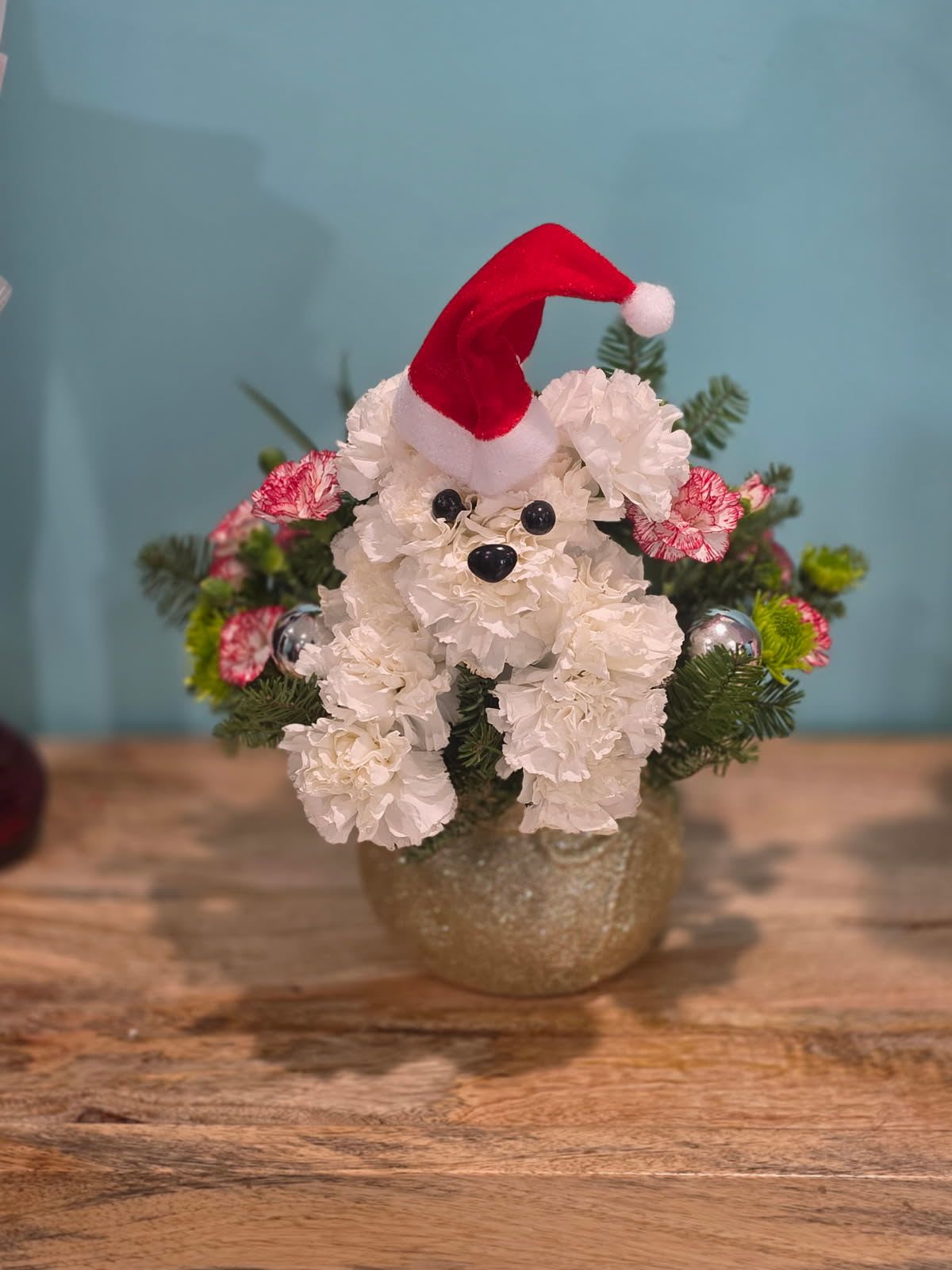 Christmas puppy surprise - A beautifully arranged puppy made with flowers.