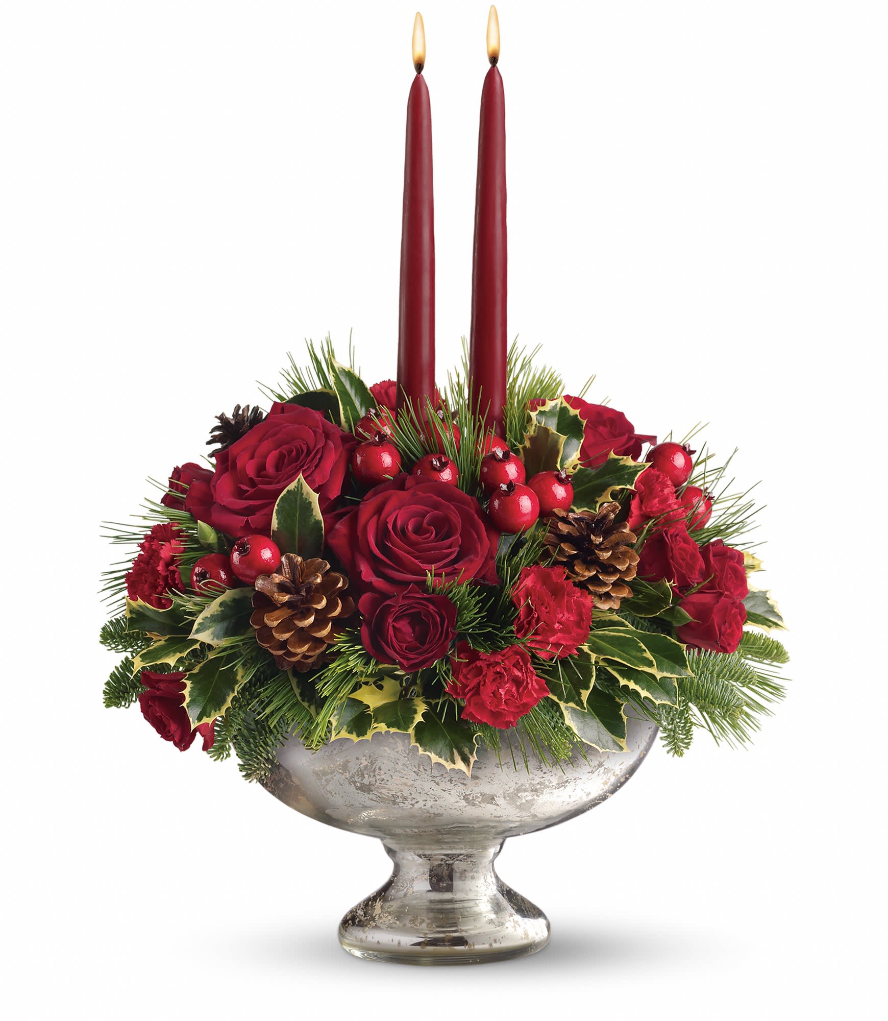 Teleflora’s Mercury Glass Bowl Bouquet    - Beautiful red roses, spray roses, carnations and berries are arranged with pine and fir branches, pinecones and holly. Two elegant taper candles complete this perfect arrangement. Approximately 14" W x 16 1/2" H  T112-1A
