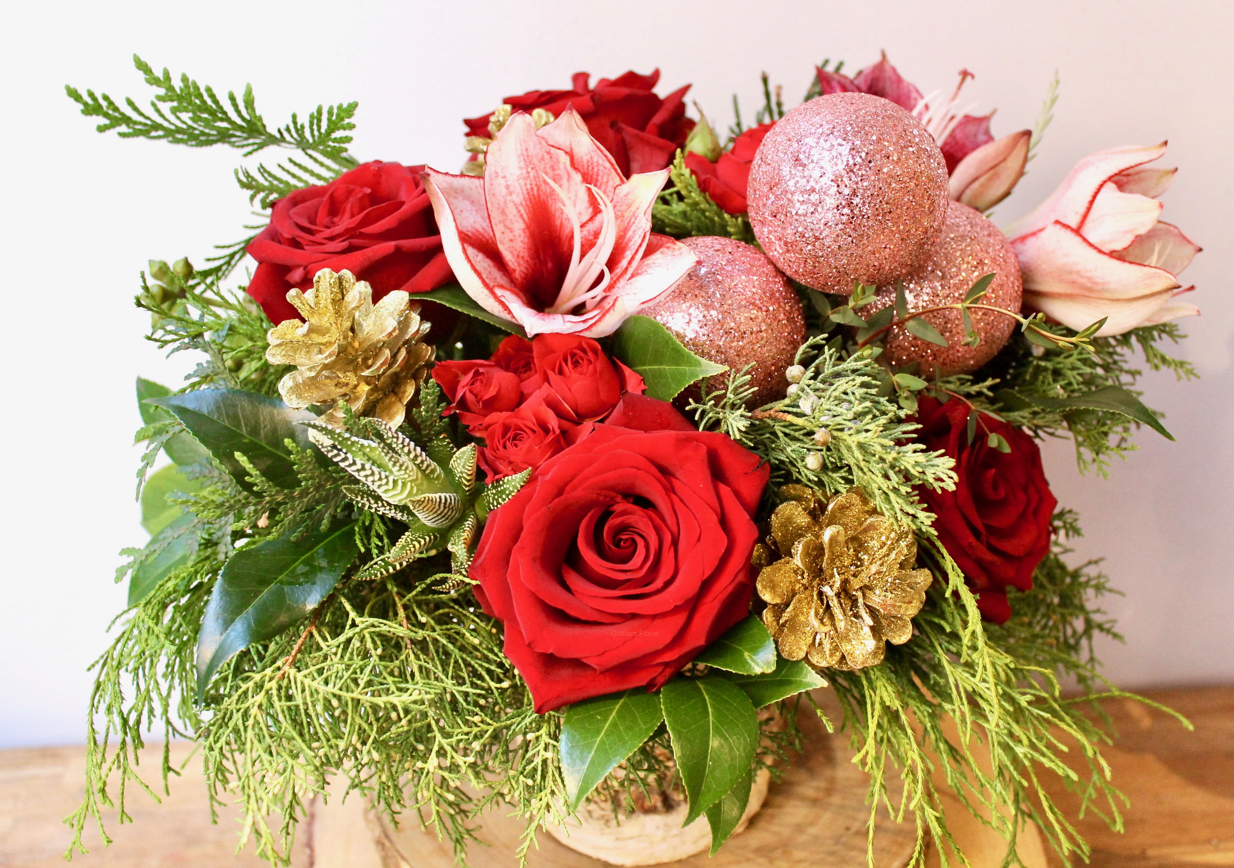 Jingle All The Way - Fresh holiday evergreens with red roses, amaryllis and holiday accents. Smells amazing in a beautiful birch vase. Send some holiday cheer from the best florist in new york. Send the best flowers from the best flower shop in New York. We offer guaranteed same day flower delivery in Manhattan, Queens, Bronx, Brooklyn, Staten Island and West Chester counties. We have the prettiest and most luxurious flowers to choose from and our designs are unique and whimsical. We carry Peonies almost every day of the year!! Send flowers today.  