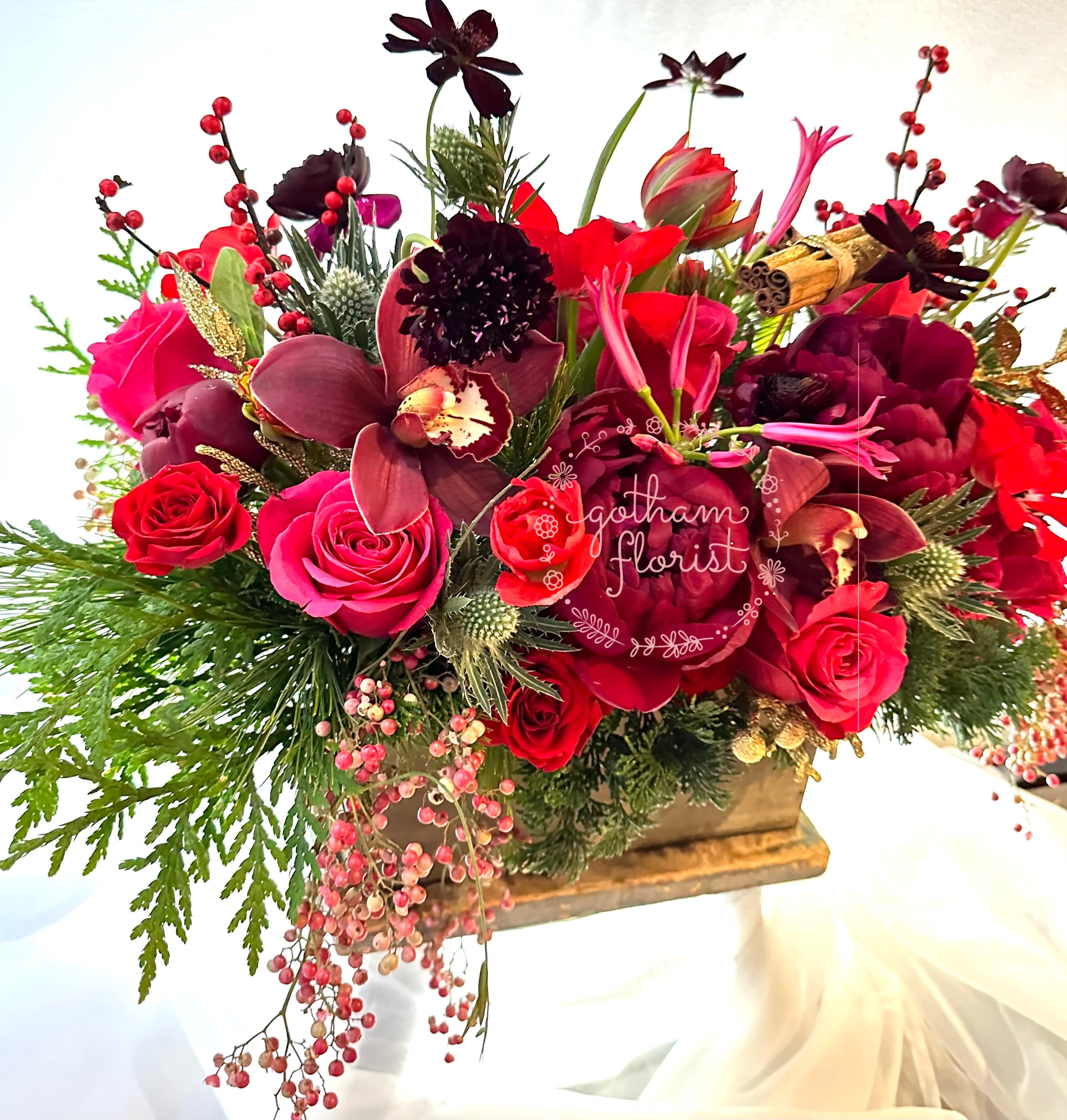 Merry - Wood planter filled with seasonal flowers and sparkly holiday decorations. Color can be customized.  Please include in special instructions. We provide luxurious floral arrangements perfect for the holidays. Send the best flowers from the best flower shop in New York. We offer same day flower delivery in Manhattan, Queens, Bronx, Brooklyn, Staten Island and West Chester counties. We have the prettiest and most luxurious flowers to choose from and our designs are unique and whimsical. We carry Peonies almost every day of the year!! 