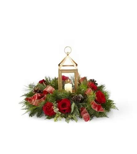 I'll Be Home For Christmas  - Bring your guests together with an elegant centerpiece worth gathering around. A stunning collection of roses, hypericum berries, carnations and Christmas greens sit around a matte golden lantern with a festive ribbon accent. Our I'll Be Home for Christmas Centerpiece helps light up every celebration this season. *Note: While the ribbon in your arrangement may change due to availability, we can promise the centerpiece will be fresh, bright and perfect for the holidays.