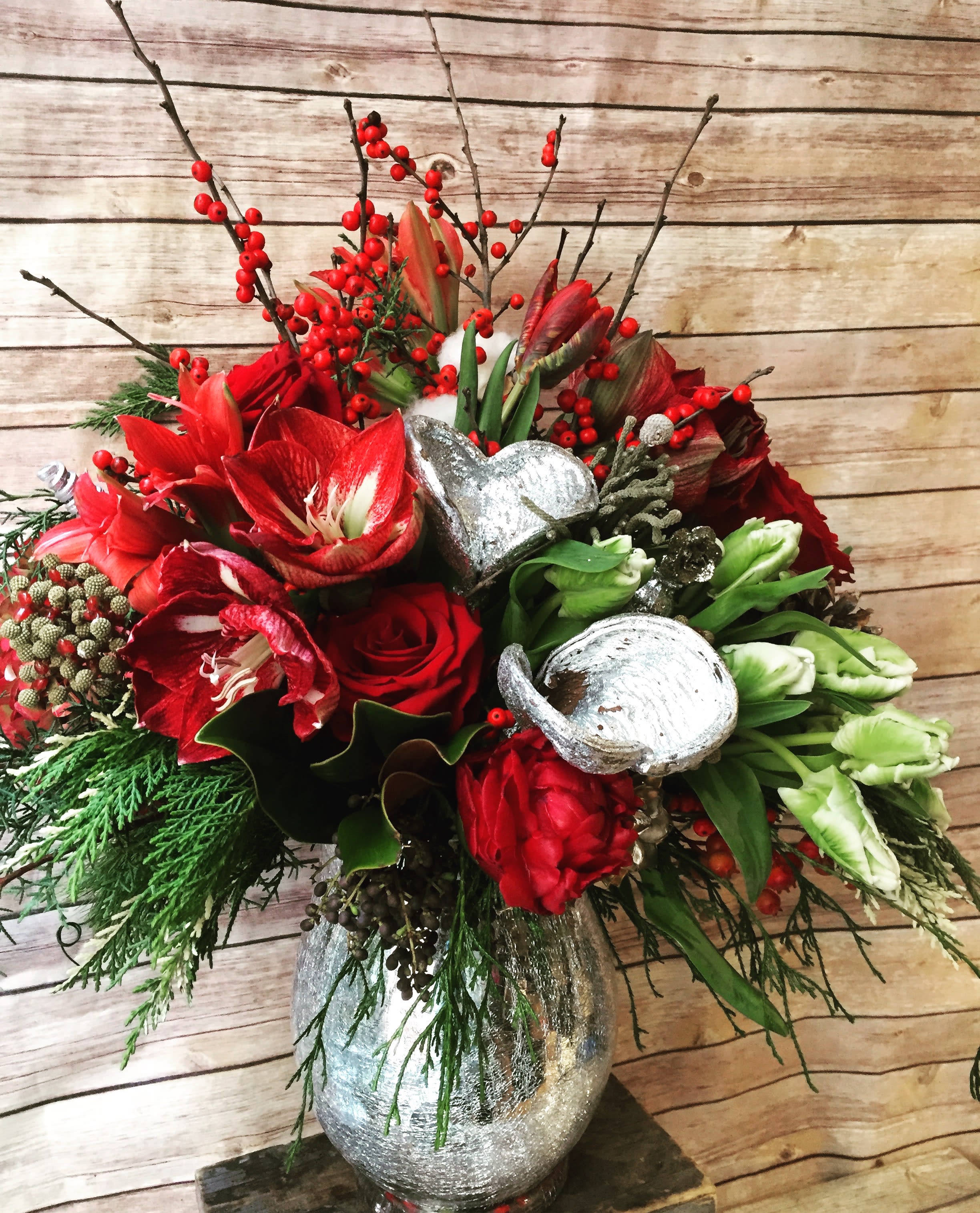 Silver Bells - Make spirits bright with the show-stopping Silver Bells holiday arrangement. This magnificent holiday centerpiece is a true feast for the senses. Overflowing with a captivating blend of textures and colors, the Silver Bells arrangement instantly transforms any space into a winter wonderland. Imagine the fresh, evergreen scent mingling with the rich hues of the berries and blooms - it's an experience your guests won't soon forget. Display this stunning piece on your dining table, entryway, or mantle to infuse your home with the magic of the holidays.  Lush evergreens, vibrant berries, and opulent blooms Adds a touch of elegance and sophistication to your decor Creates a warm, inviting ambiance perfect for entertaining Handcrafted to last throughout the holiday season  We offer same day flower delivery in Manhattan, Queens, Bronx, Brooklyn, Staten Island and West Chester counties. We have the prettiest and most luxurious flowers to choose from and our designs are unique and whimsical. We carry Peonies almost every day of the year!! Best florist, nyc, local florist, send flowers, flower delivery, same day delivery, florist around me, flower shop, best flower shop, flowers, flower delivery, peony, peonies, same day flower delivery, wedding florist, best florist nyc, nyc florist, florist near me, manhattan florist, brooklyn florist