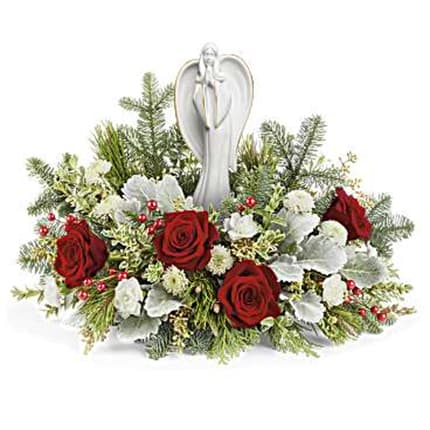 Blessed Serenity Bouquet - Embodying the spirit of Christmas, the Angel of Grace rests among a bed of red and white blooms, illuminating your special occasion with joy and light. 