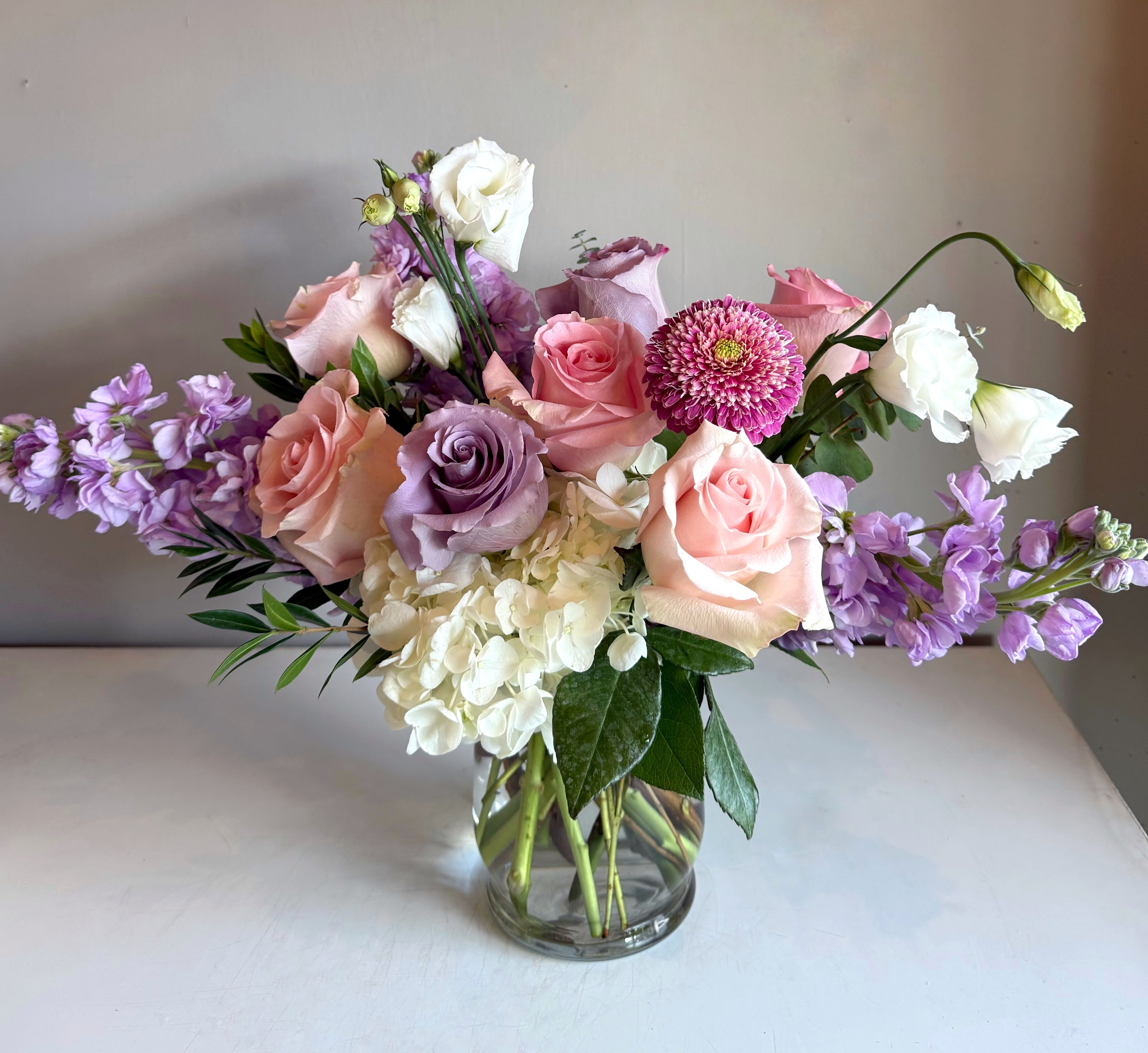 Linnea - Linnea is a soft yet cheerful gathering of blush pink roses, hydrangeas, Ocean Song soft lavender roses, with a touch of white blooms in season. 