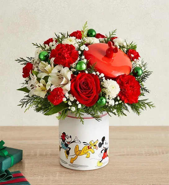 Disney Cookie Jar - Share a holiday surprise full of character(s)! Part of our exclusive Disney collection, this handcrafted bouquet is gathered in joyful Christmas colors and designed in our whimsical Mickey Mouse and Friends cookie jar, featuring iconic animations of the whole gang. Great as a keepsake container or to keep your favorite treats, it’s a sweet and nostalgic surprise for every Disney fan.