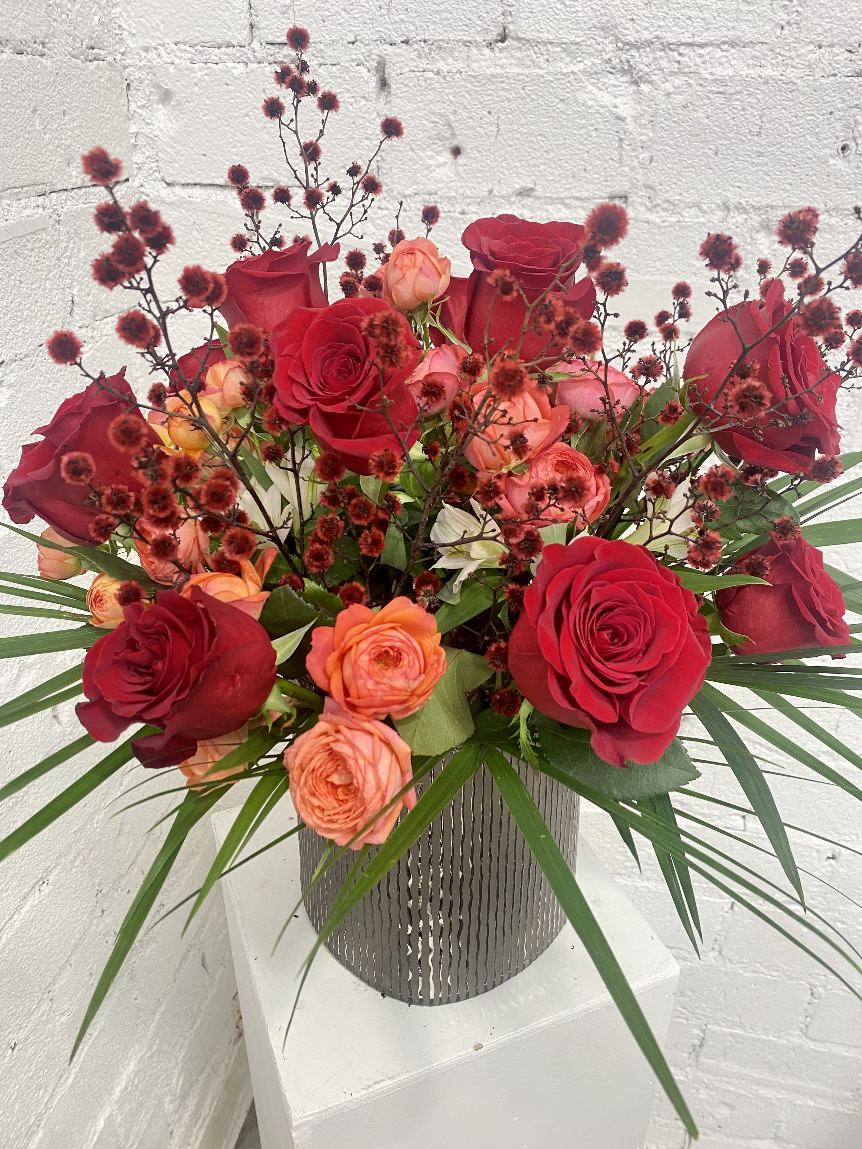 Christmas Cheer  - Dozen upscale red roses and spray garden roses mixed with rich fillers and greenery.
