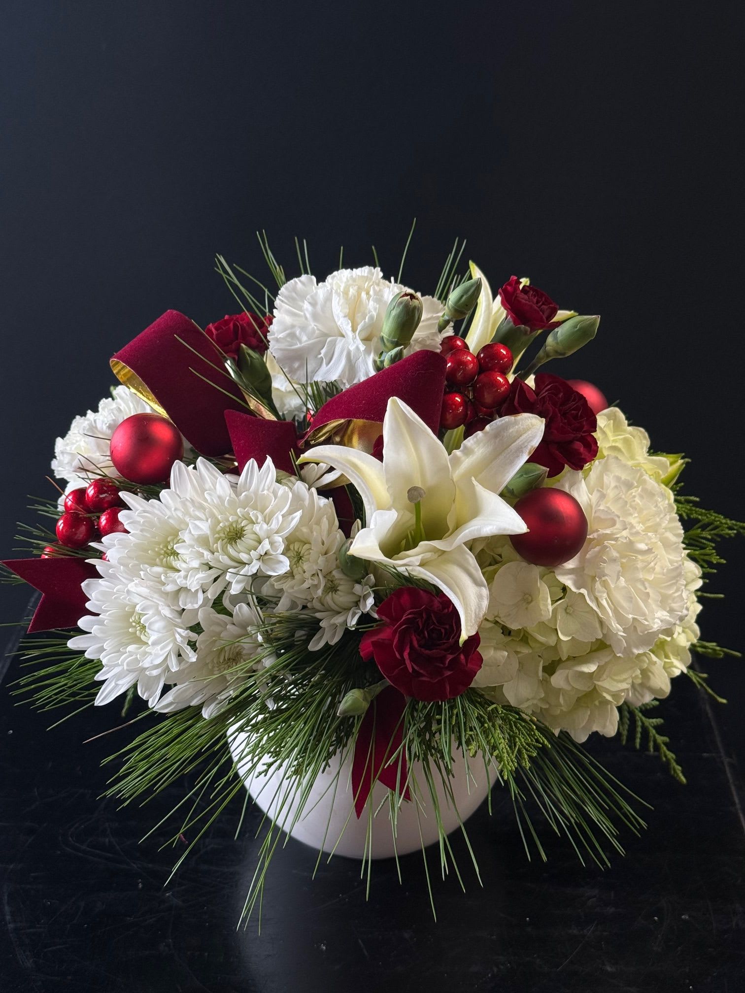 Frosted Winter - Winter spirit filled arrangement with cushion mums, carnations, mini carnations, lily, hydrangea and wintergreens