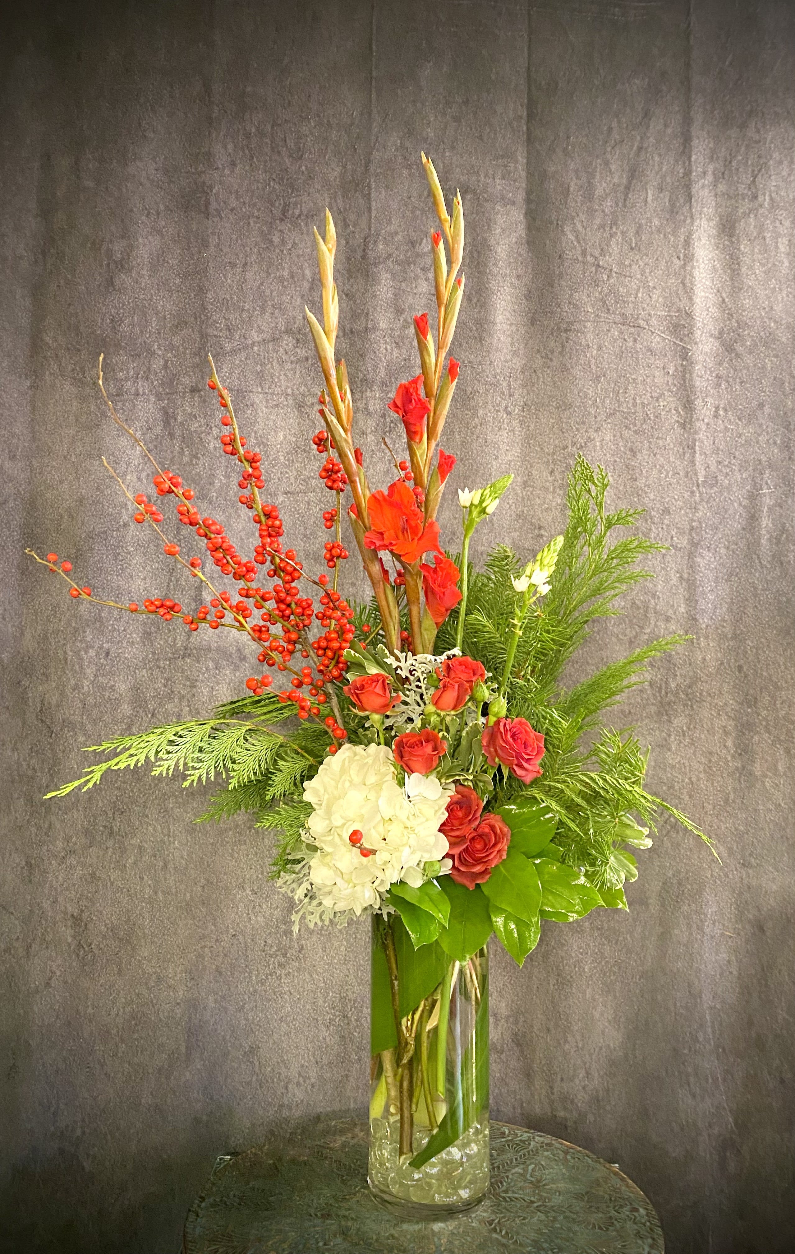 Sugar Plum - This elegant, distinctive and soft design will add a touch of winter sweetness to anyone's day. Colors of Red, white and pink with Winterberry, Hydrangea, Star of Bethlehem, Gladiolus and a mix of winter and tropical foliage.
