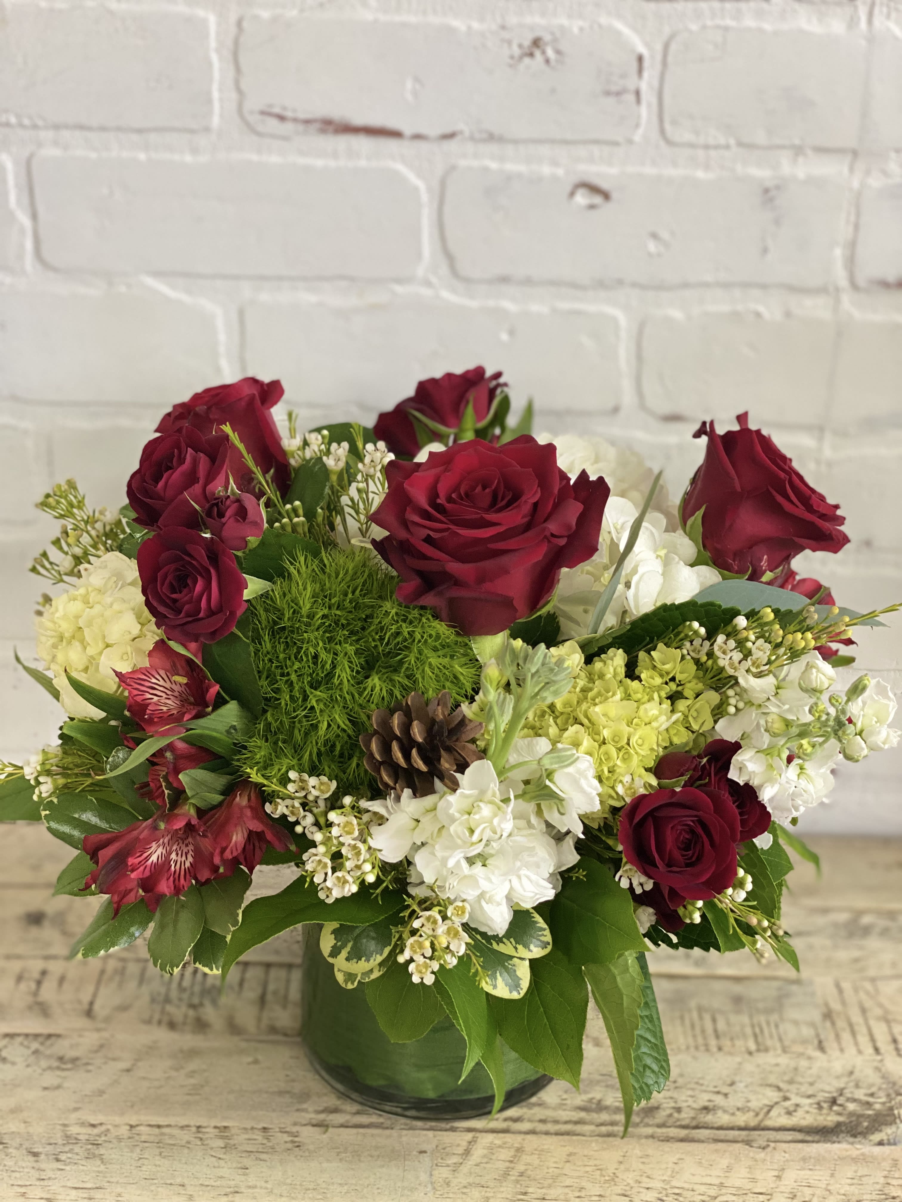 Merry Little Christmas - Christmas arrangement with hydrangea, roses, stock and other beautiful blooms in a glass cylinder 