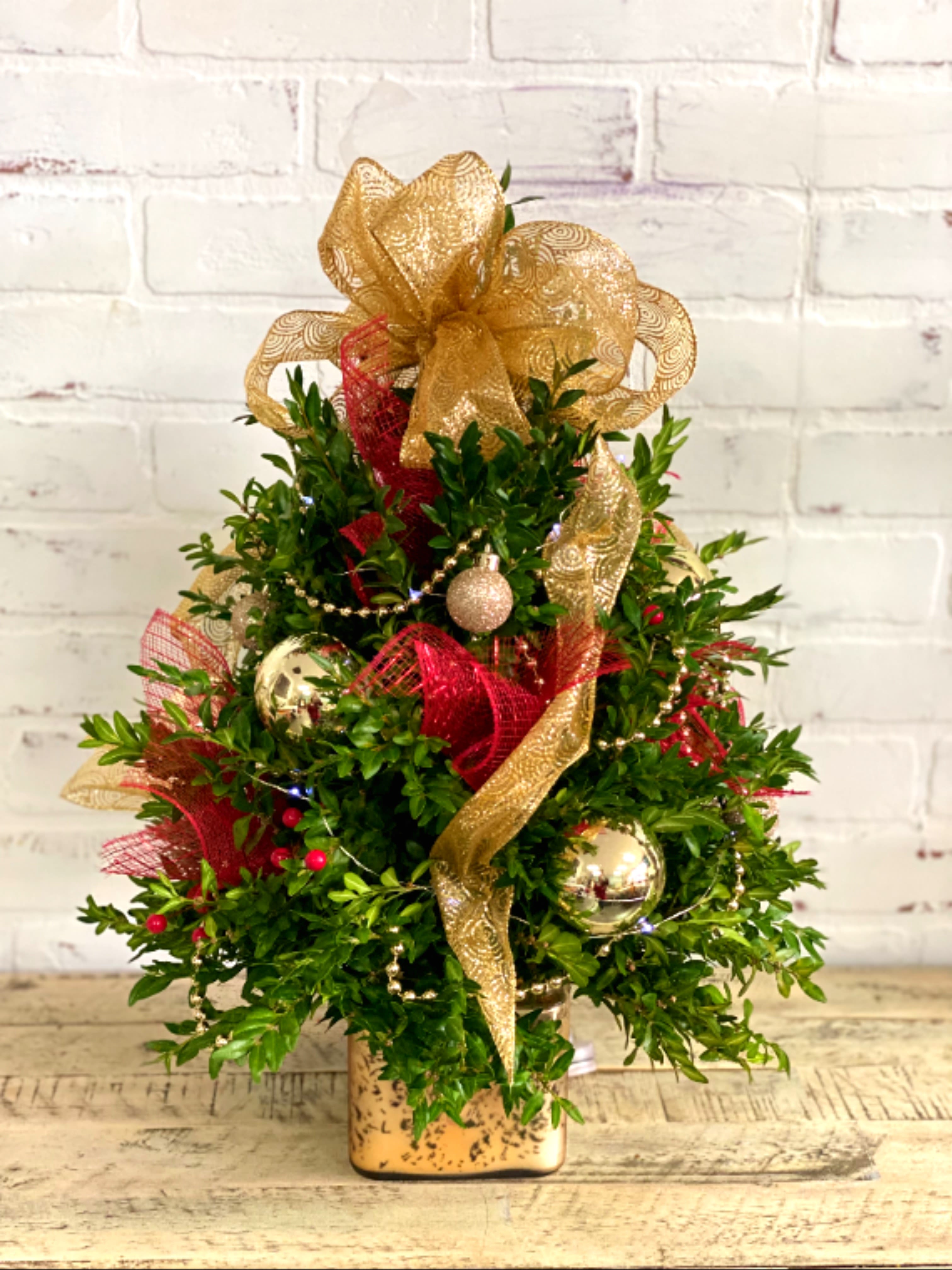 Christmas Boxwood Tree - Christmas tree centerpiece made out of fresh greens and dressed up in assorted holiday decor