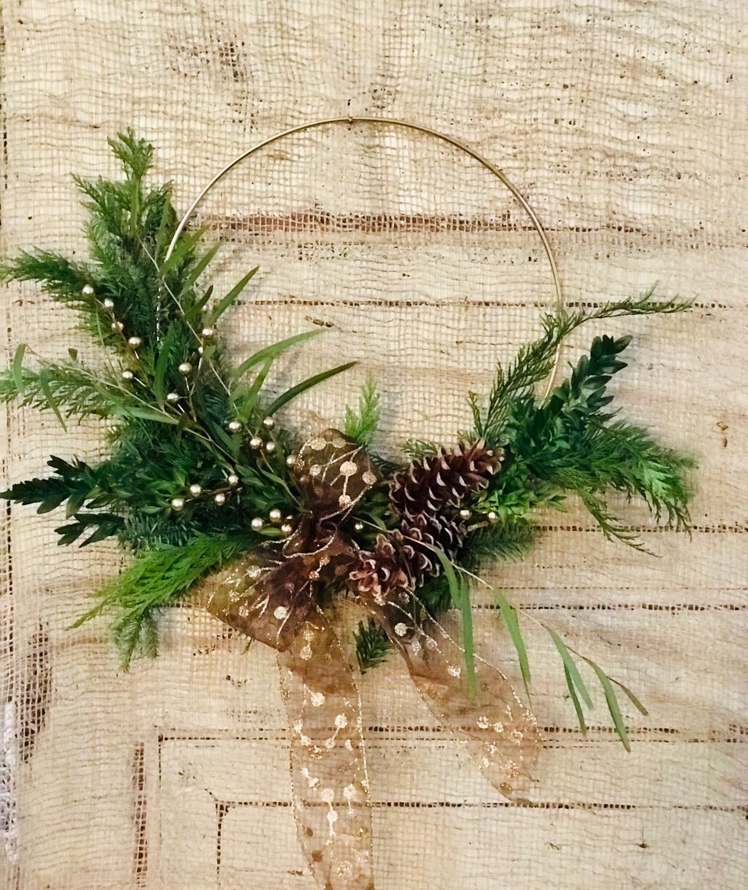 Modern Wreath - Evergreens, ribbon, berries and pinecones accent a 12&quot; gold hoop base for a modern holiday gift.
