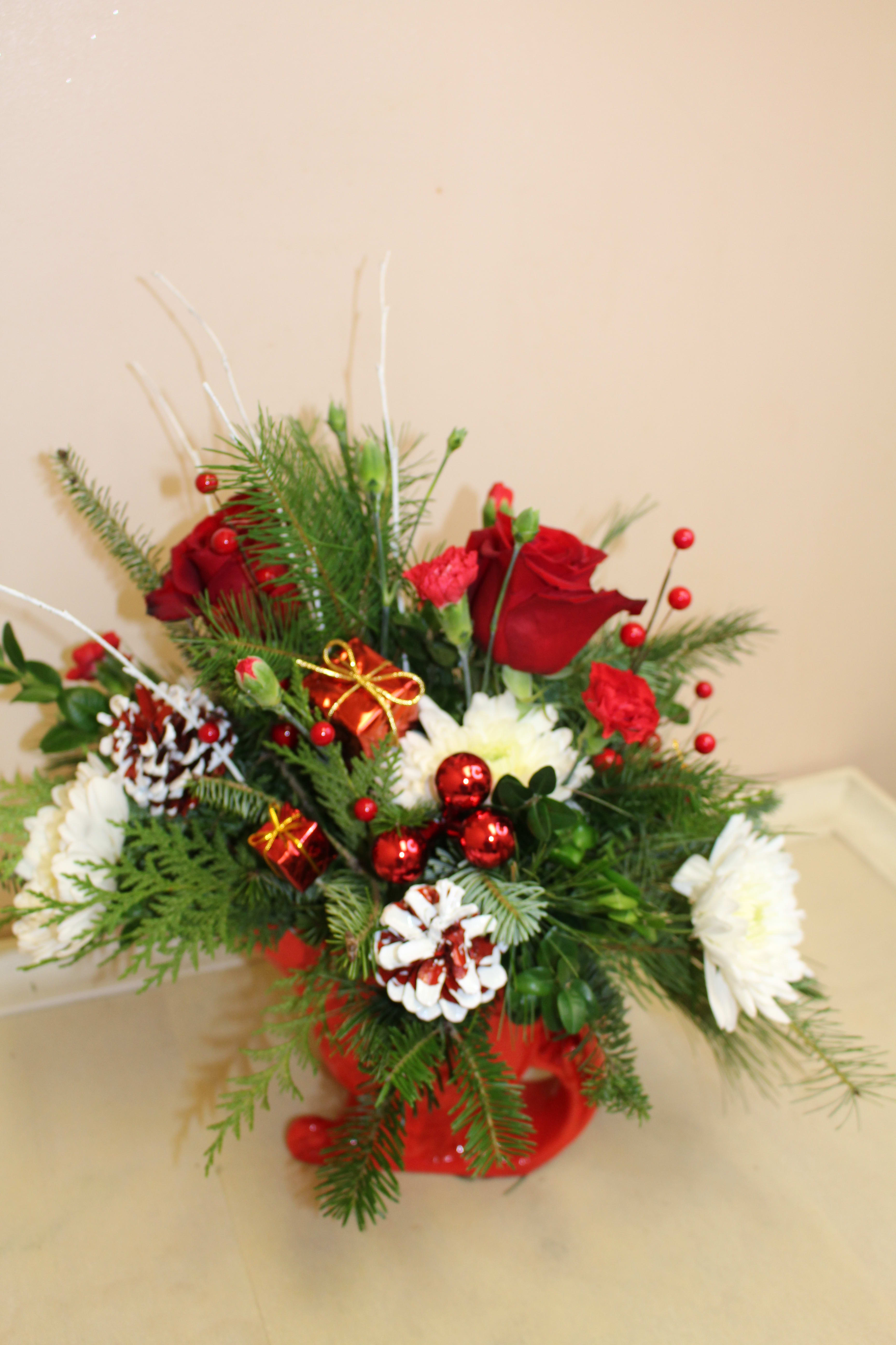 sleigh bells - a ceramic red sleigh filled with a holiday arrangement