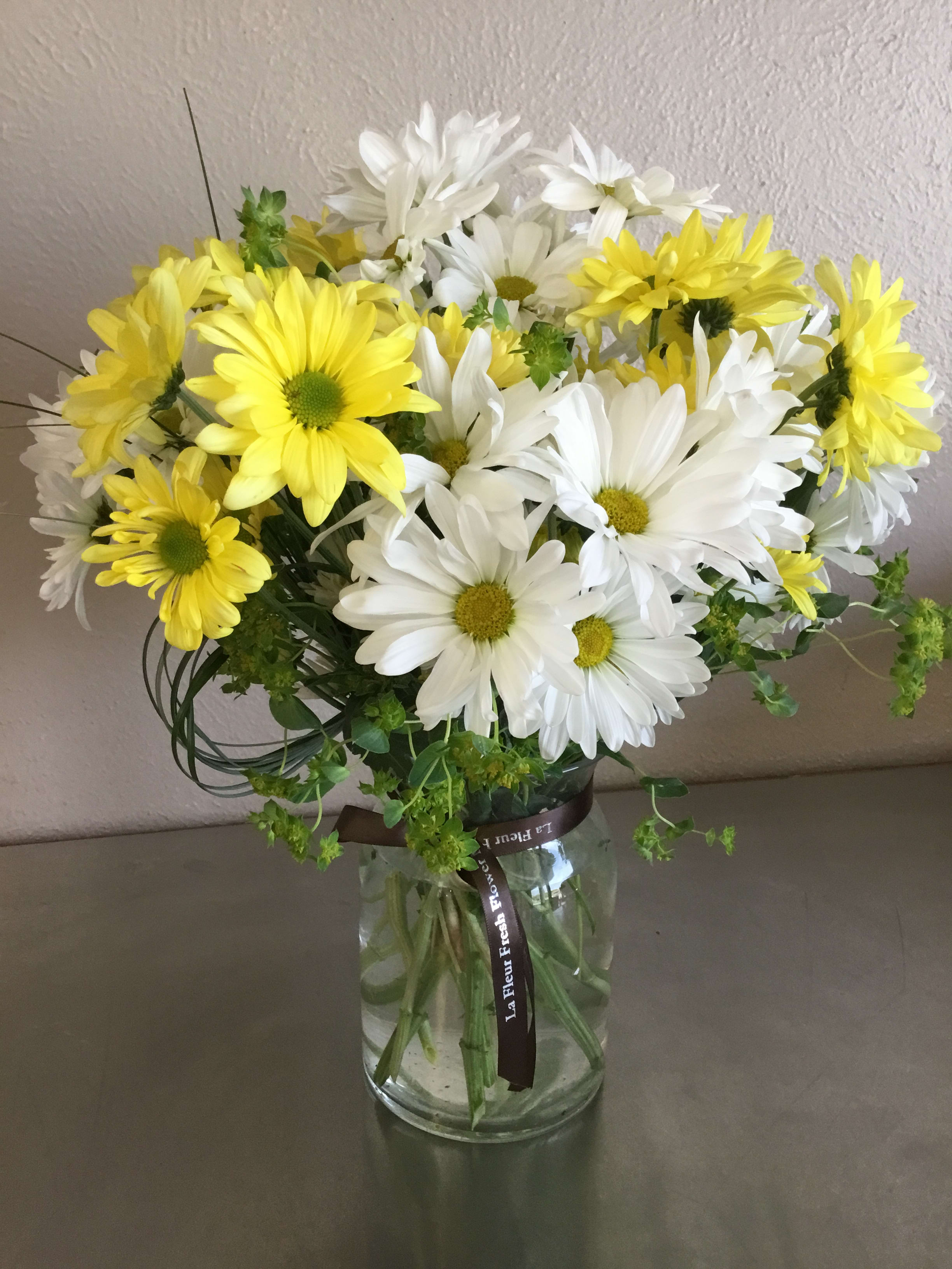Marguerite - Overflowing with daisies (color may vary) and accompanying greenery/filler