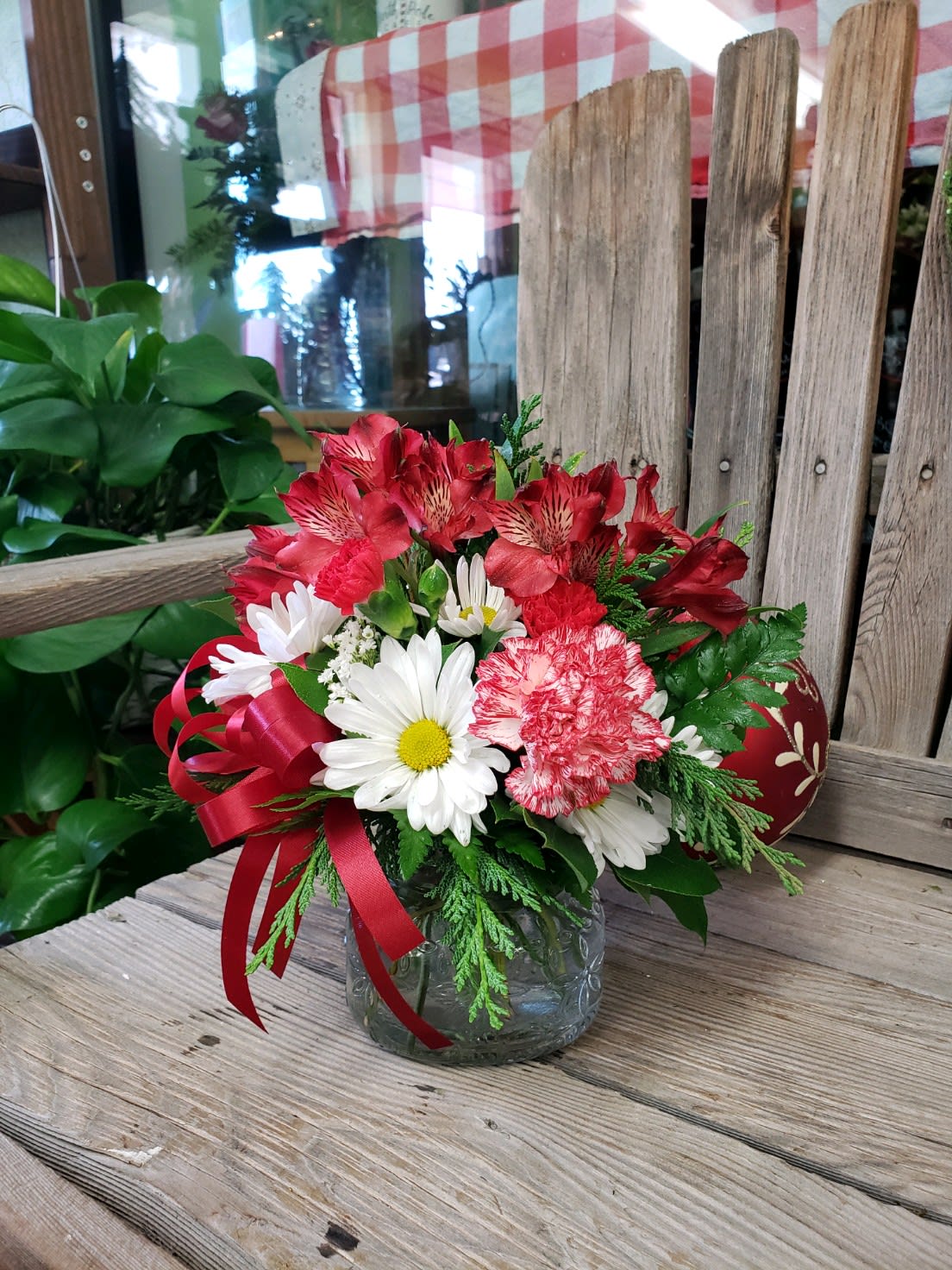 Holiday Wishes - Send sweet Holiday Wishes to That special someone today! Perfectly sized for a desk, cubicle or other small space. Fresh pine greens accompany white chrysanthemums, frilly carnations and dainty Peruvian lilies finished off with a festive bow. Their sure to love its long lasting scent and beauty! 