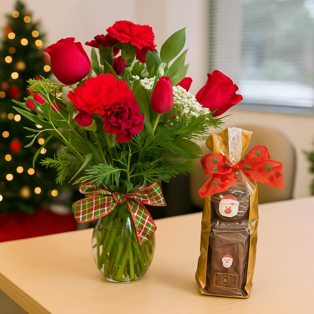 Joyful Christmas Bundle (Includes HPC Gift pack) - Immerse yourself in the holiday spirit with our Joyful Christmas Arrangement. This festive display is carefully designed to captivate and inspire the joy of the season. Featuring:  This bouquet features a delightful combination of tulips, carnations, and spray roses, perfectly balanced to capture the freshness and color of the season.  Festive Accents  Adorned with Christmas greens and a natural pine cone, this design brings a subtle touch of holiday cheer while maintaining timeless simplicity.  Perfectly Simple Design Ideal for decorating your table, gifting, or adding a cheerful touch to your home.  Hawaiian Paradise Candies Small Gift Pack Pair the beauty of the season with the sweetness of the tropics! Our Hawaiian Paradise Candies Small Gift Pack includes:  Locally produced confections made with the finest island-inspired ingredients. A mix of chocolates, caramels, and nut clusters infused with tropical flavors like macadamia, coconut, and pineapple. Packaged in a charming, holiday-ready box, perfect for gifting or personal indulgence.  Together, these make a perfect holiday gift set that combines festive elegance with a touch of tropical sweetness. Let the Christmas Wonderland Arrangement bring the magic, while the Hawaiian Paradise Candies add the delicious finishing touch!