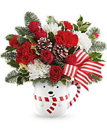 Teleflora's Send a Hug® Cozy Cub Wish Bouquet - Send warm holiday hugs with Teleflora's Send a Hug® Cozy Cub Wish Bouquet! Festive red blooms and fresh greens arrive in Teleflora's adorable bear mug-perfect for Christmas cheer and cozy winter gifting. Teleflora's Send a Hug® Cozy Cub Wish Bouquet includes red spray roses, red carnations, red miniature carnations, and white cushion spray chrysanthemums. Accented with noble fir and variegated holly in Teleflora's Send a Hug® Cozy Cub Wish Mug