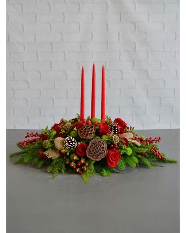 Traditional centerpiece will last the whole season with tender loving care!!! - A grand centerpiece that will certainly elevate the look of any holiday table, Christmas Cheer features red roses, lotus pods, hypericum berries, snow-tipped pinecones, scabiosa pods, and abundant fresh holiday greens. Finished with three tall taper candles, this lovely design is sure to be a focal point at any event this season.100.00