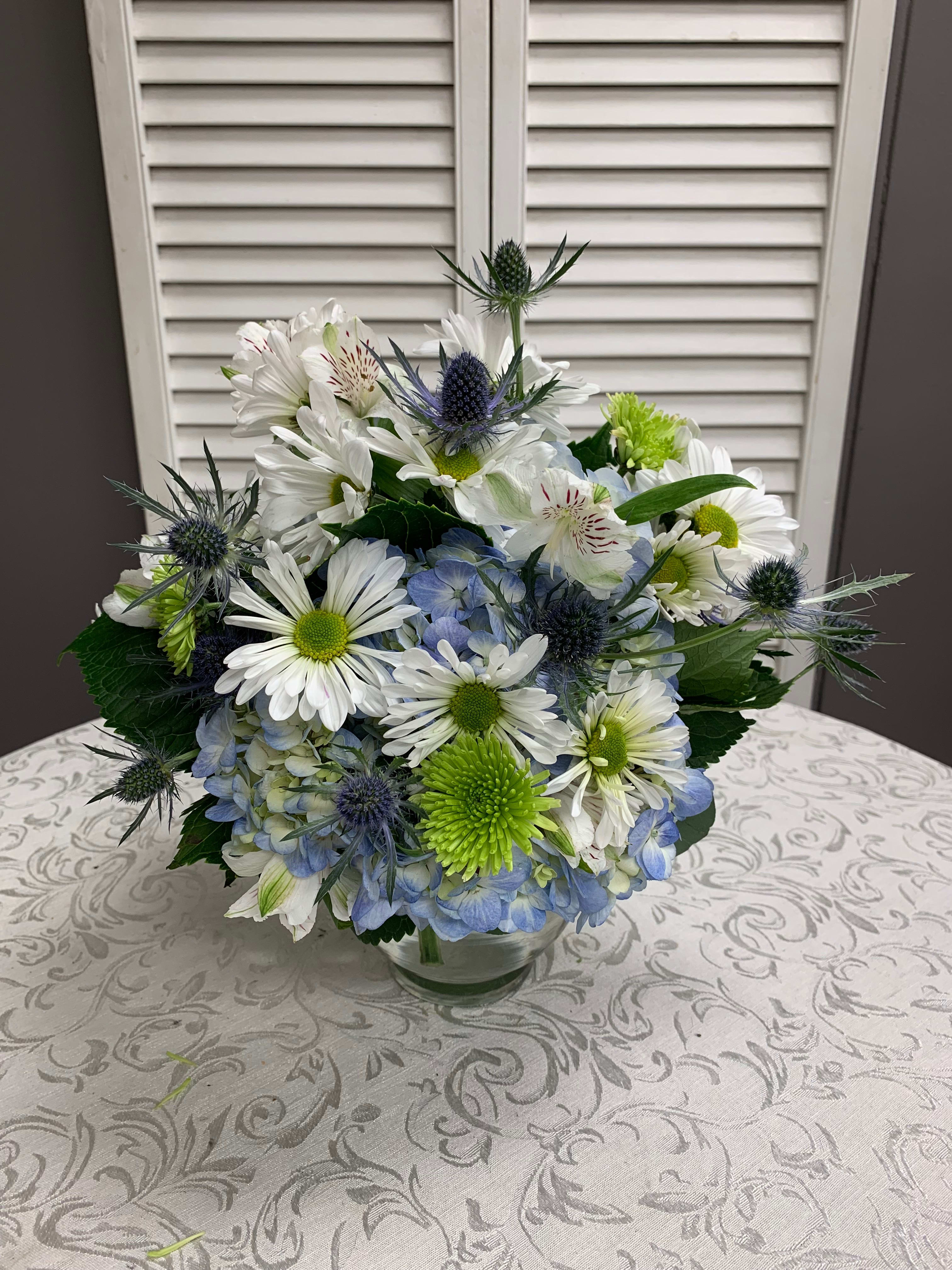Baby Blues - Arrangement is created with Hydrangea, Alstromeria, Daisies, Pomps and Thistle. 
