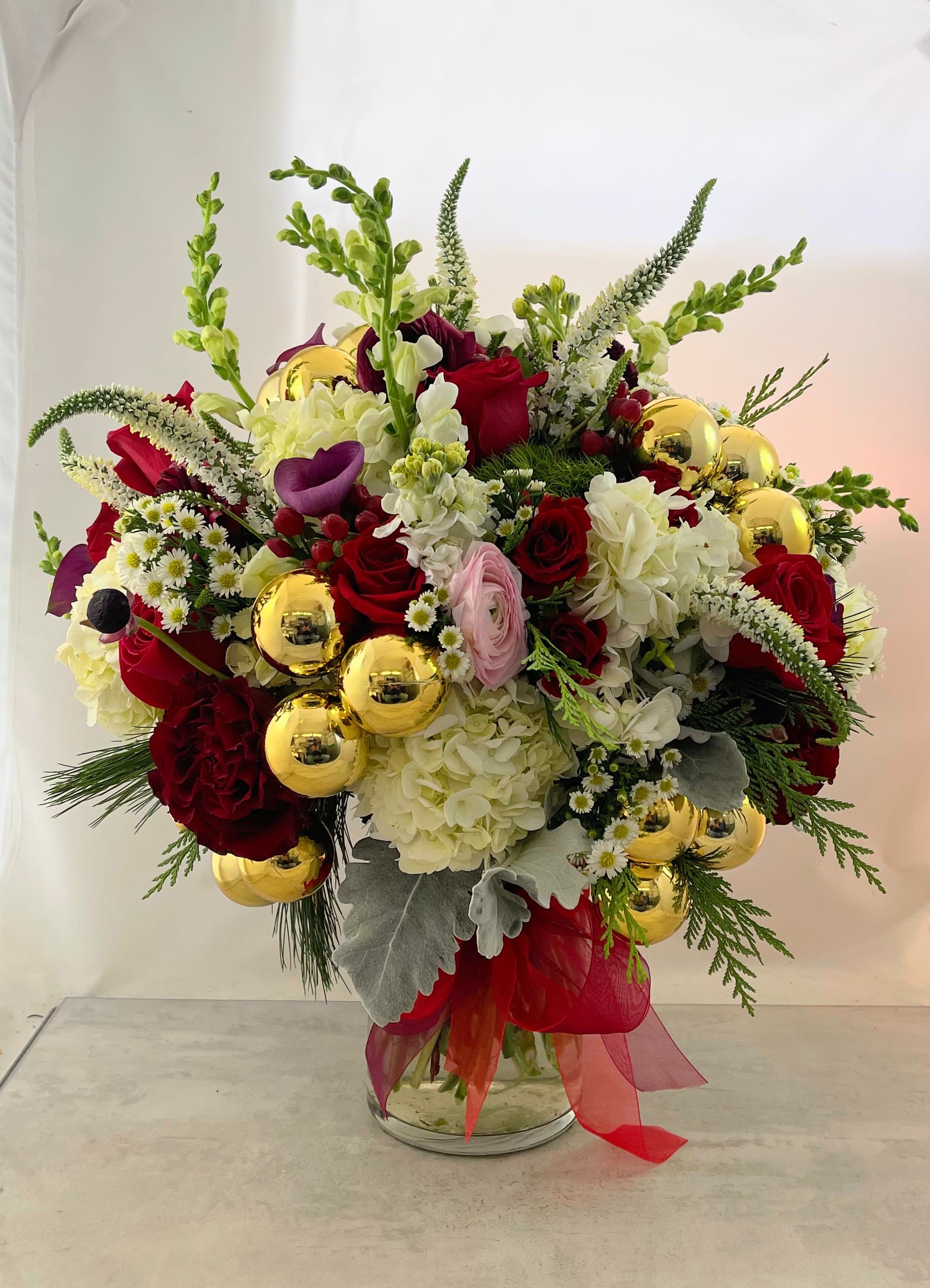 Tannenbaum Bouquet - Grace, elegance and style are a few words that describe the warm, old-world spirit of this bouquet. Hearkening memories of Christmast's past, the Tannenbaum bouquet will be front and center while your friends and family creat new ones.
