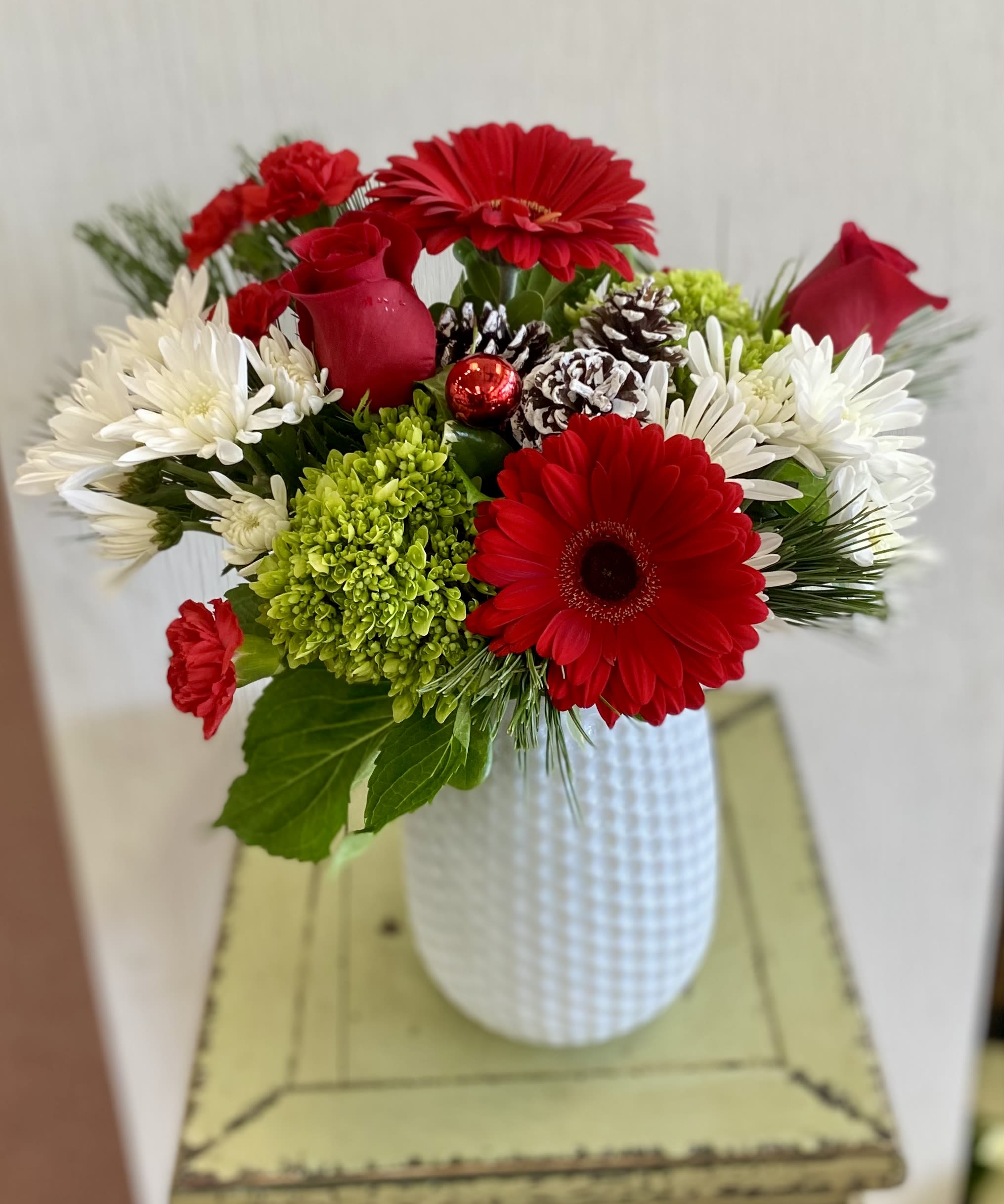 Home for the Holidays - A pretty vase overflowing with our stellar red roses, hydrangea, and seasonal blooms and greenery. A Bestseller!