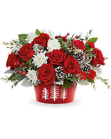 Teleflora's Snowy Pines Centerpiece - Teleflora Holiday Collection | Local Delivery Only  Celebrate the season with Teleflora's Snowy Pines Centerpiece. Bursting with red roses and white blooms in Teleflora's Snowy Pines Dish, this festive design brings winter magic to Christmas tables and holiday gatherings. Featuring red roses, red miniature carnations, white cushion spray chrysanthemums, and white limonium. Accented seasonal greenery and pinecones in Teleflora's food-safe Snowy Pines Dish.