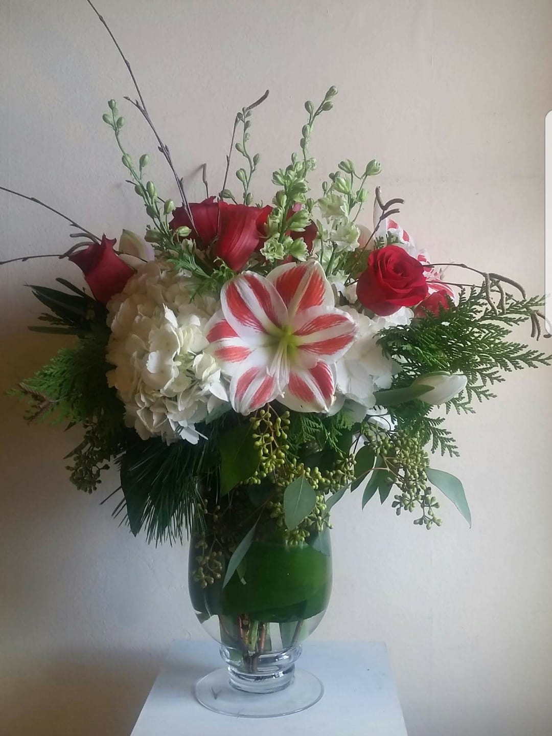 Candy Cane Christmas - White hydrangea, red roses, amaryllis and seasonal foliage. 