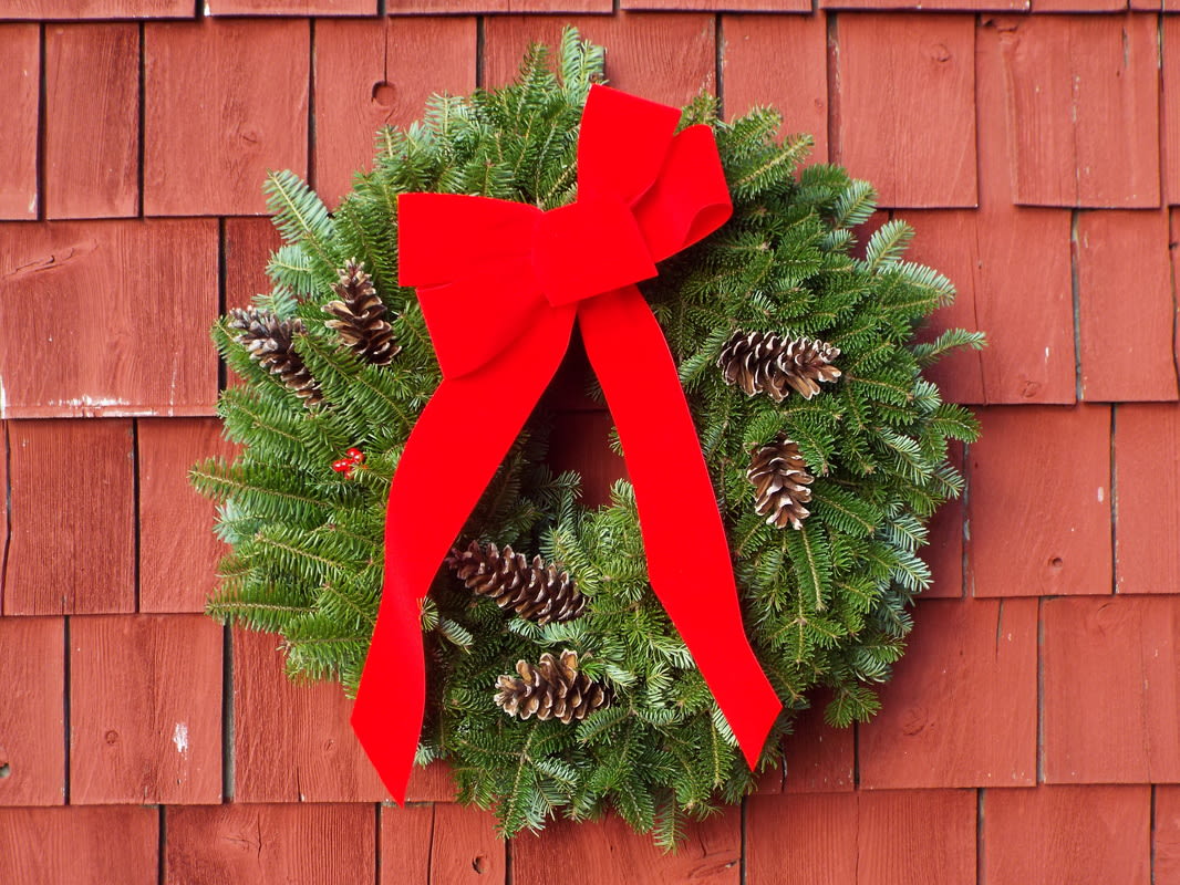24 Inch Evergreen Wreath - Beautiful full evergreen wreath. Adorned with pine cones and a bow. Made to last. 