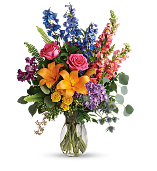 Colors of the Rainbow - This colorful bouquet includes purple hydrangea, pink roses, yellow spray roses, orange asiatic lilies, purple alstroemeria, blue delphinium, pink snapdragons, blue eryngium, huckleberry, oregonia, Israeli ruscus, sword fern, silver dollar eucalyptus, seeded eucalyptus, and lemon leaf.  