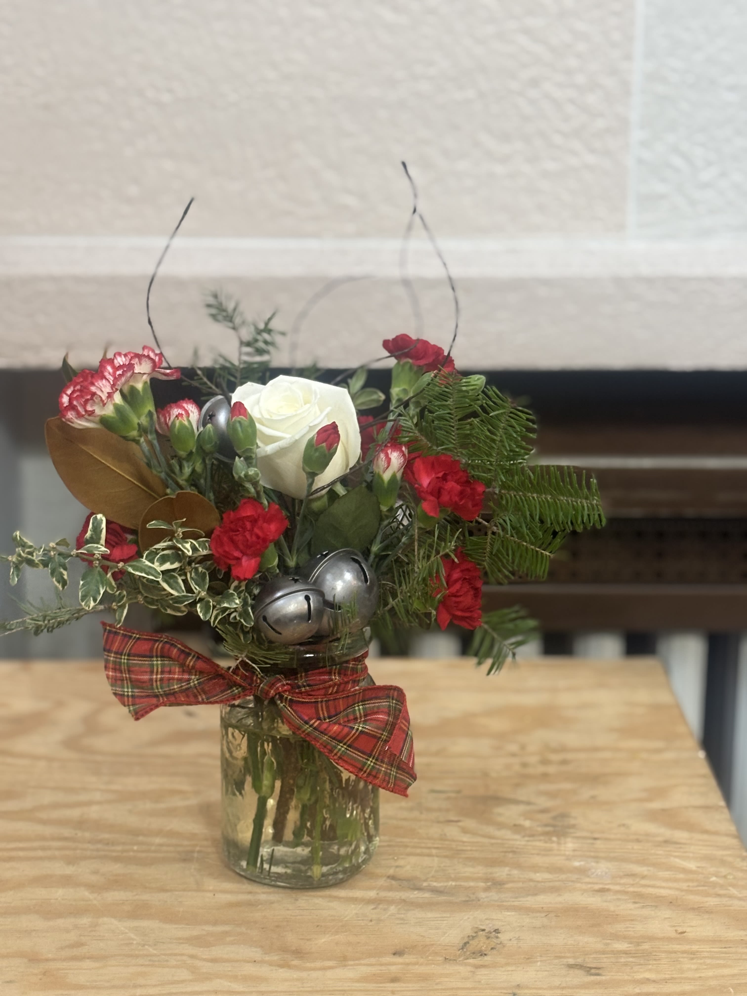 All Is Bright Vase  - A Christmas vase with bells, carnations, Christmas Greens, and a rose. 