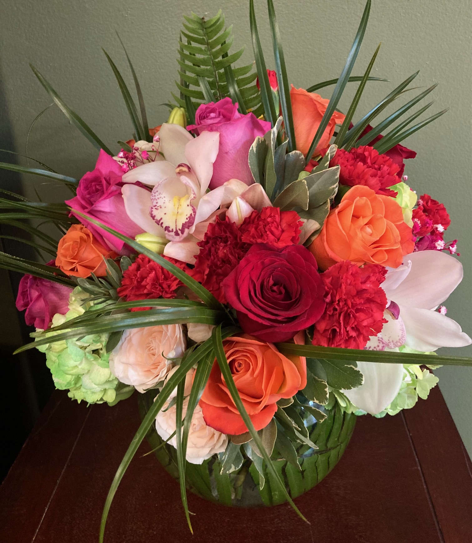 Bowl Of Beauty Designer Choice - Let our designers create a vibrant and colorful arrangement using the freshest and brightest blooms available! Bubble vase included. Photo shows deluxe version.