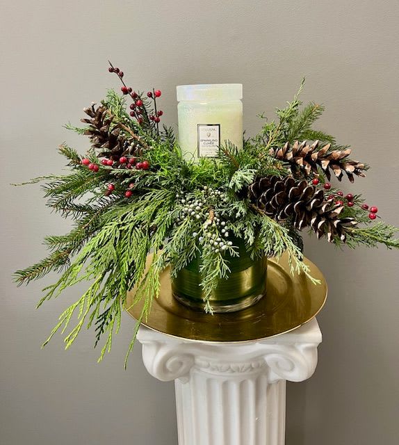 HOLIDAY GLOW - This design features a large 18oz Sparkling Cuvee Voluspa candle surrounded by gorgeous Balsam, Cedar, and Juniper accented with pinecones.  This is the gift that will keep on giving long after the season is over, this Voluspa candle burns for over 100 hours. 