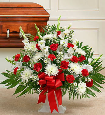 Tribute Red &amp; White Floor Basket Arrangement - When you just can't seem to find the words, let this touching arrangement help you express your deepest condolences. Hand-arranged by our florists in a floor basket, which is customary to send to the funeral home, this tasteful gathering lets you express all the emotion you have in your heart at this difficult time. With red blooms to symbolize love and white blooms to symbolize respect,  a truly beautiful way to let friends and loved ones know how much you care. Appropriate for family, friends or business associates to send directly to the funeral hom Our florists use only the freshest flowers available, so colors and varieties may vary.                    