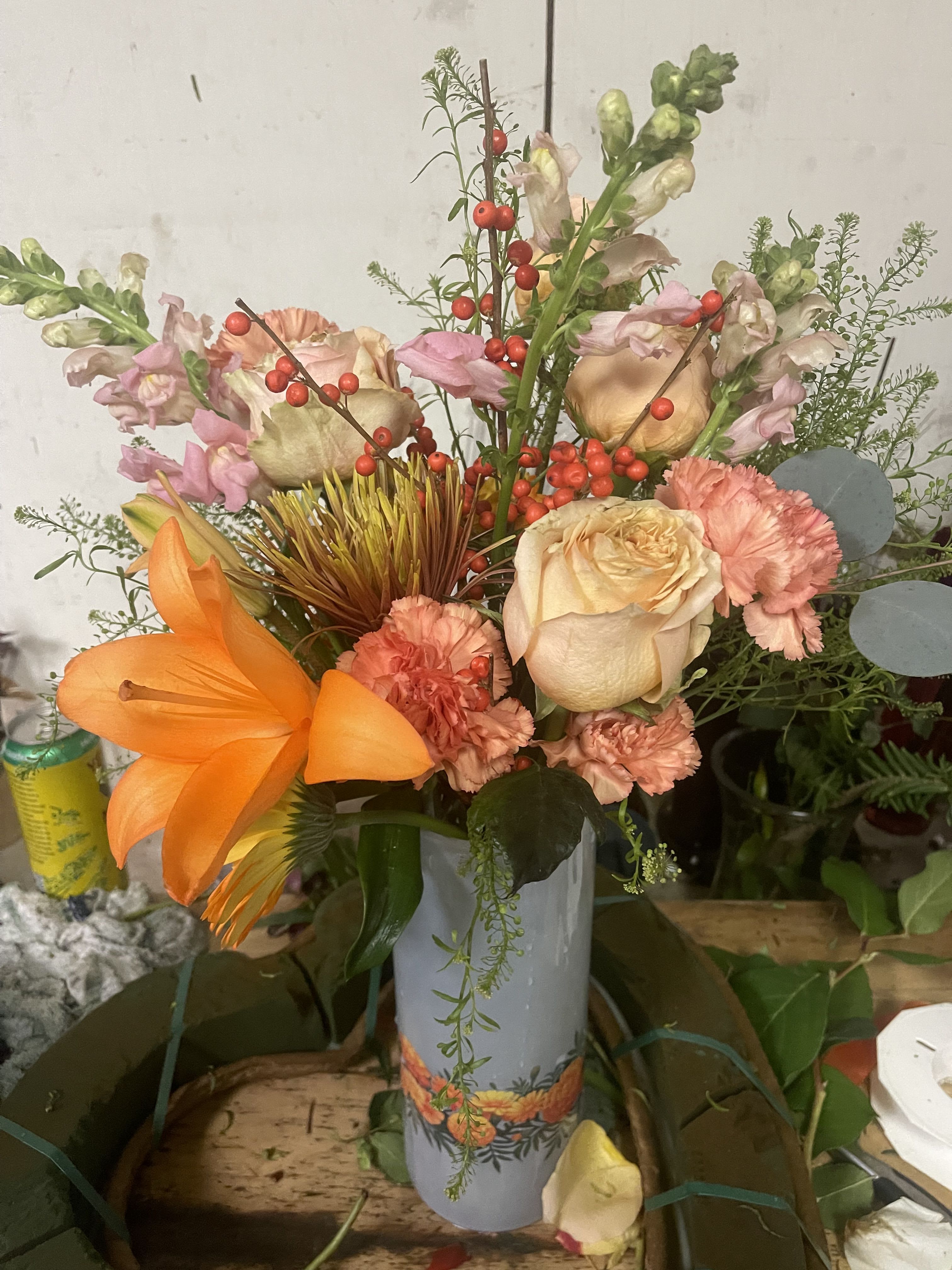 Fall Dream  - Fall arrangement or winter arrangement containing with vivid orange flower colors, tuba roses lilies in the arranged in a vase