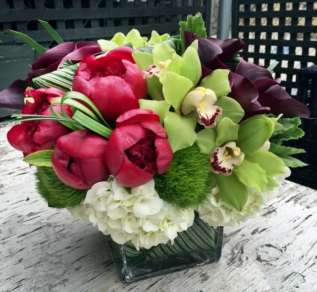 Red Charm - Featuring the amazing &quot;Red Charm&quot; peony, this bouquet is bursting with elegance and style. Paired with deep purple calla lilies, hydrangeas, and green orchids, the arrangement is a wonderful gift for anyone who appreciates the finer things in life. Approx. 14&quot; overall. Call for Saturday delivery.