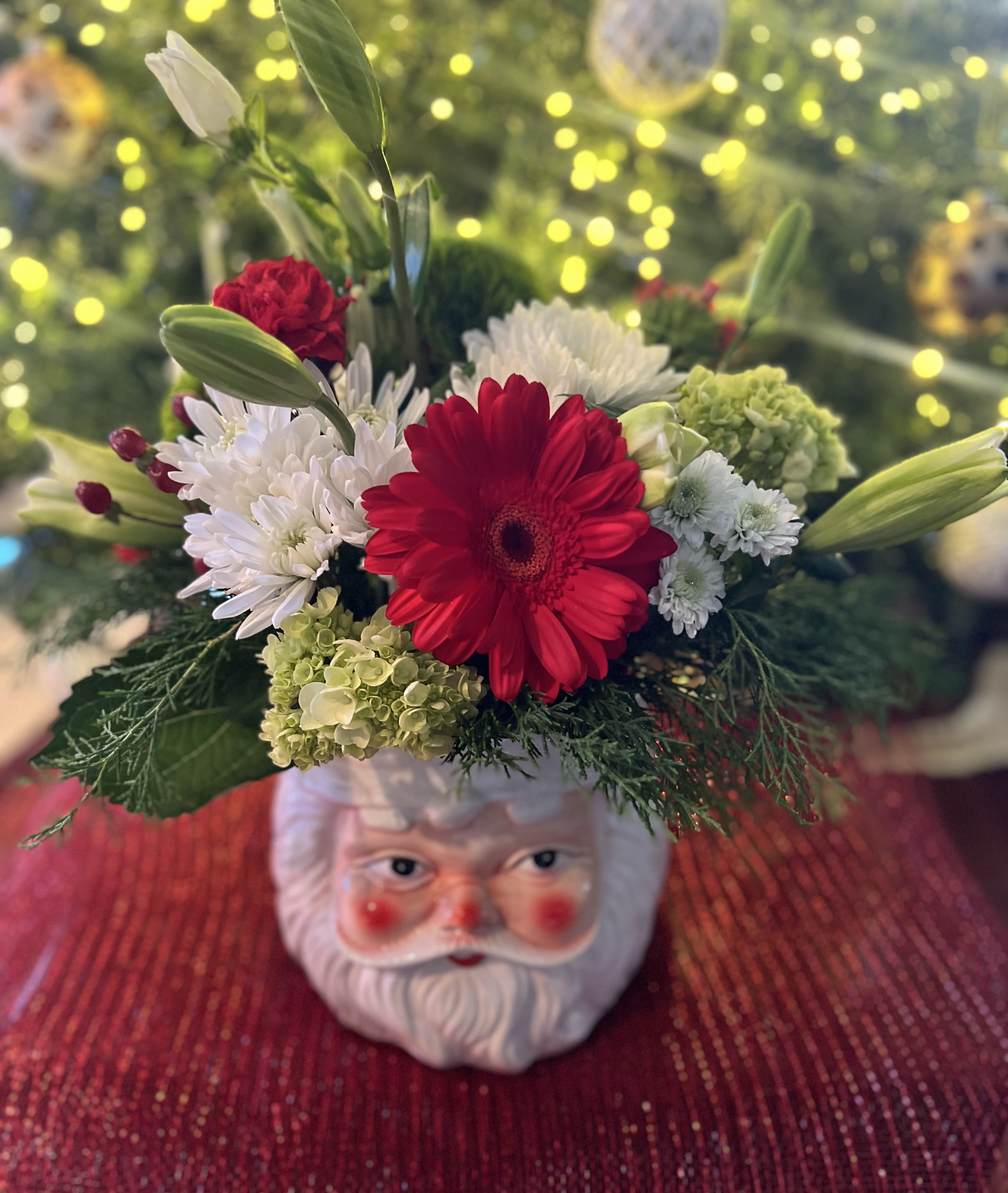 “SANTA BABY” CERAMIC FRESH FLORAL VASE ARRANGEMENT - Designers Choice of Christmas florals placed on a large decorative “SANTA CLAUSE” Colorful Ceramic Vase with a Season Greeting Pic