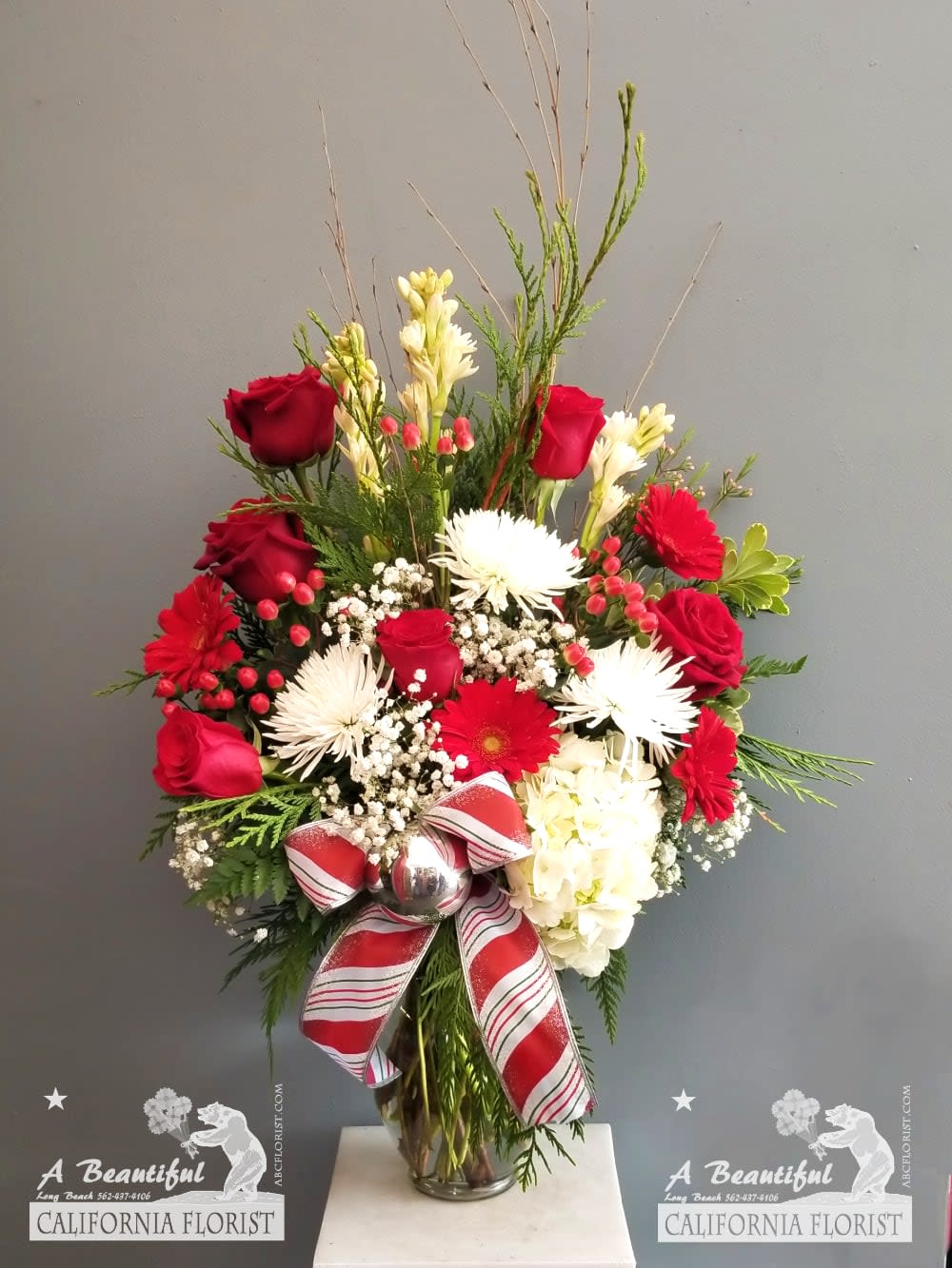 Christmas in Long Beach - Beautiful blooms in the colors of Christmas beautifully arranged and ready to be enjoyed. Order Christmas in Long Beach for same day delivery or in store pickup from Long Beach CA favorite five 5 star flower shop, A Beautiful California Florist. Approx. 34&quot; T x 24&quot; W 