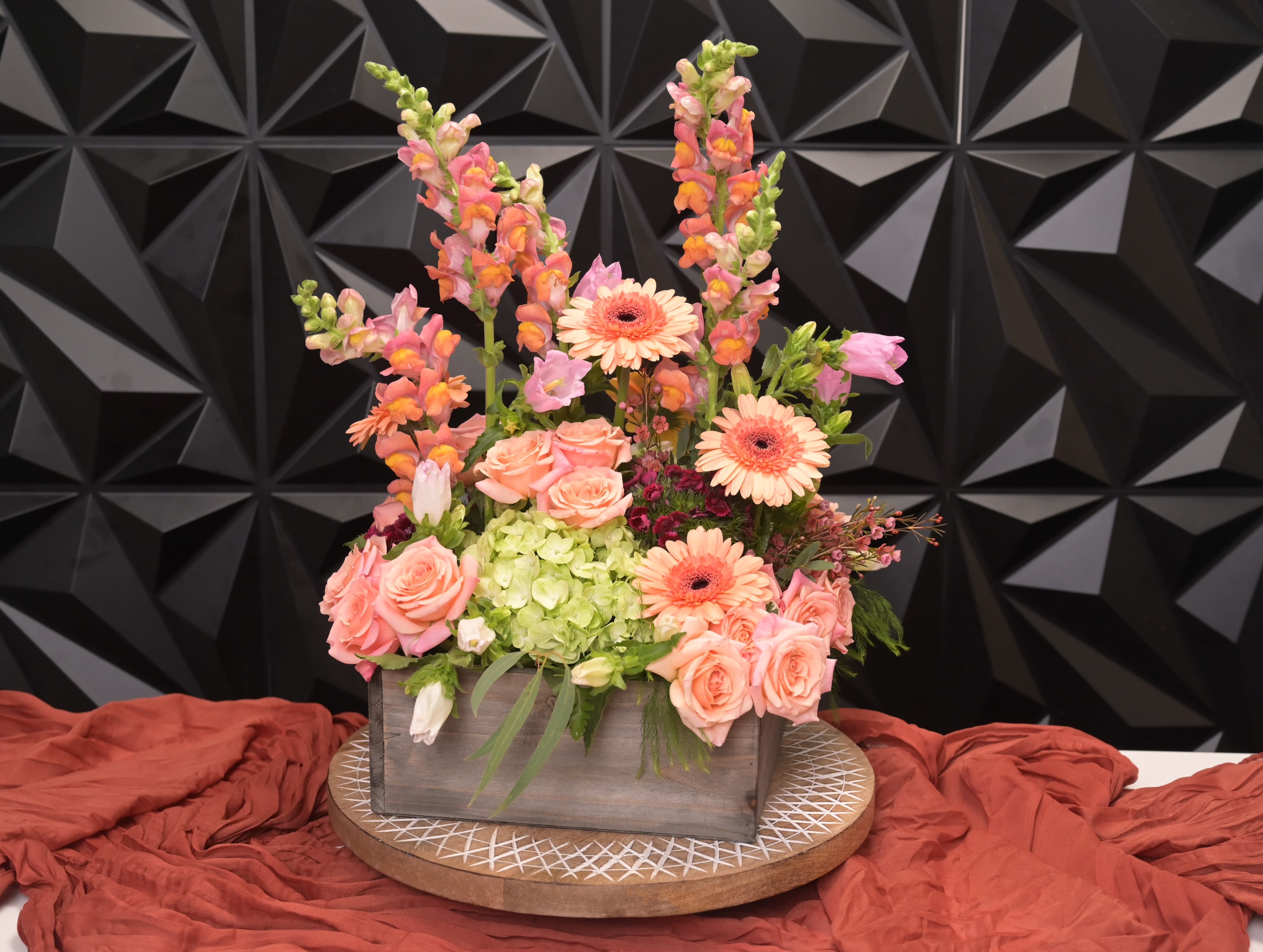 Eva - Eva Soft, romantic, and beautifully expressive, Eva is a fresh burst of elegance designed in a textural stone-washed vessel that enhances its modern charm. This arrangement blends warm coral tones, airy pastels, and sculptural garden textures to create a composition that feels uplifting, feminine, and effortlessly refined. Its layered height and flowing movement make it a standout piece for celebrations, thank-yous, or anyone who deserves something truly special. A statement of joy and artistry in one luxurious design. Please Note: Our arrangements are handcrafted, and no two pieces are ever identical. Variations in flower types, color tones, and exact placement will occur based on daily availability. We do not create factory-duplicate designs — instead, we recreate the style, palette, and overall feel of the arrangement while ensuring every piece is fresh, beautiful, and premium.