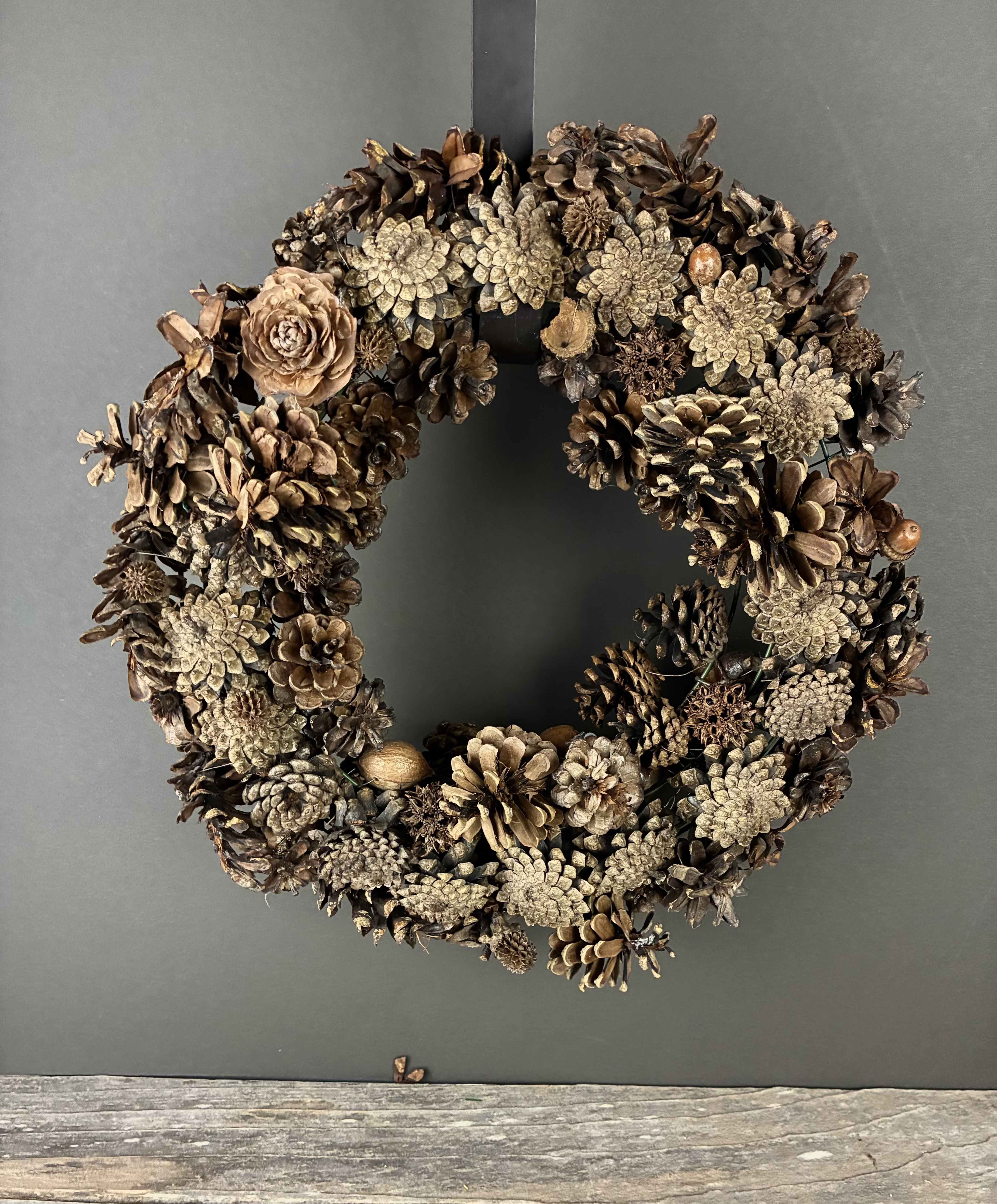 Nature's Bounty Wreathe - Celebrate your love of nature with this wreathe of pinecones!  Measurements: 13in across All of our wreathes are hand made by our designers and we never make the exact same wreathe twice! If you would like a wreathe similar to this one, please call or email the shop.