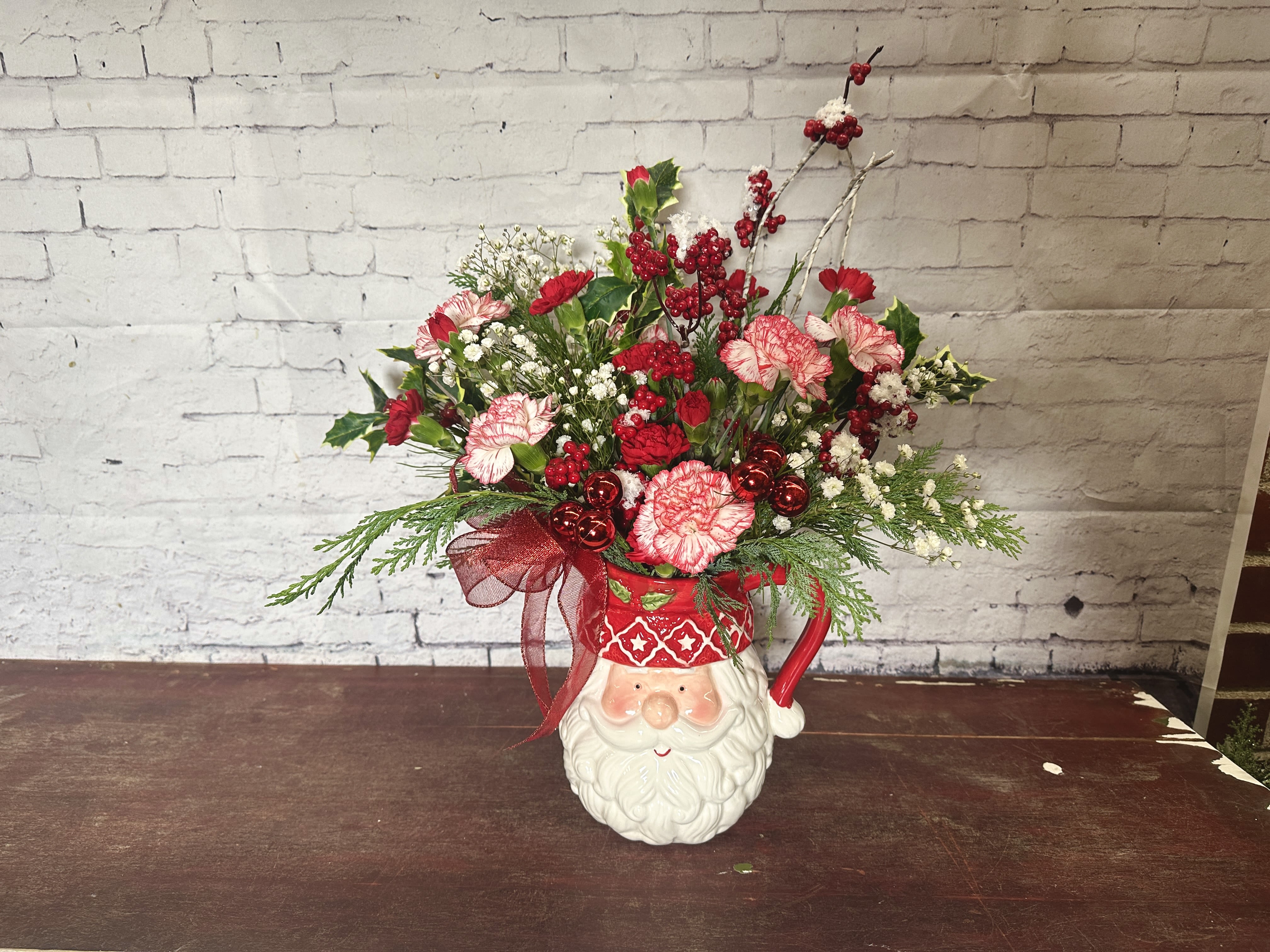 Peppermint Santa surprise  - Santa pitcher filled with festive Christmas florals 