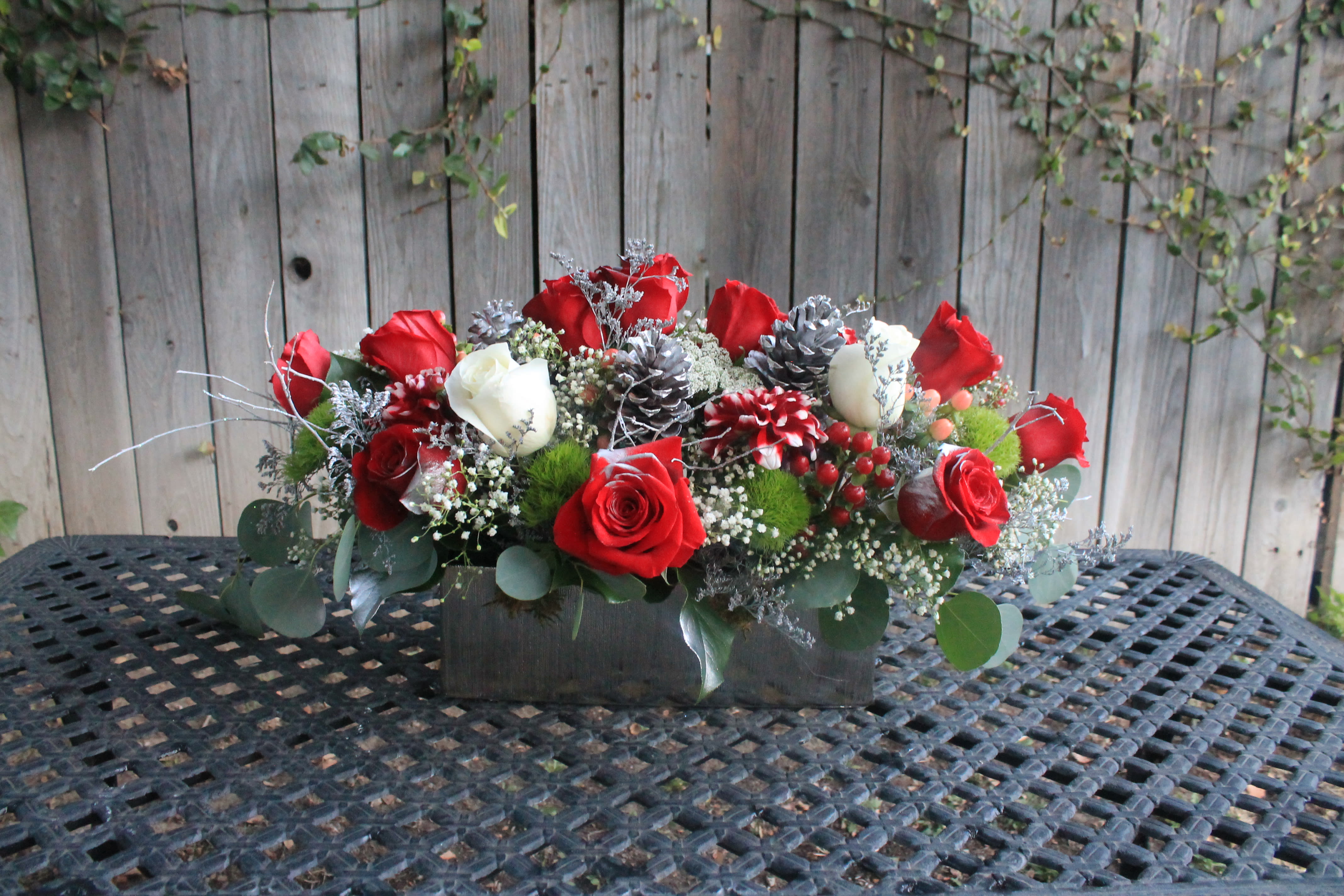 Buon natale - Buon natale translating to Merry Christmas, makes the perfect table centerpiece for the holidays. Red and white roses and other beautiful accents that will make your table the best table. It can also be customized to your specific request. 