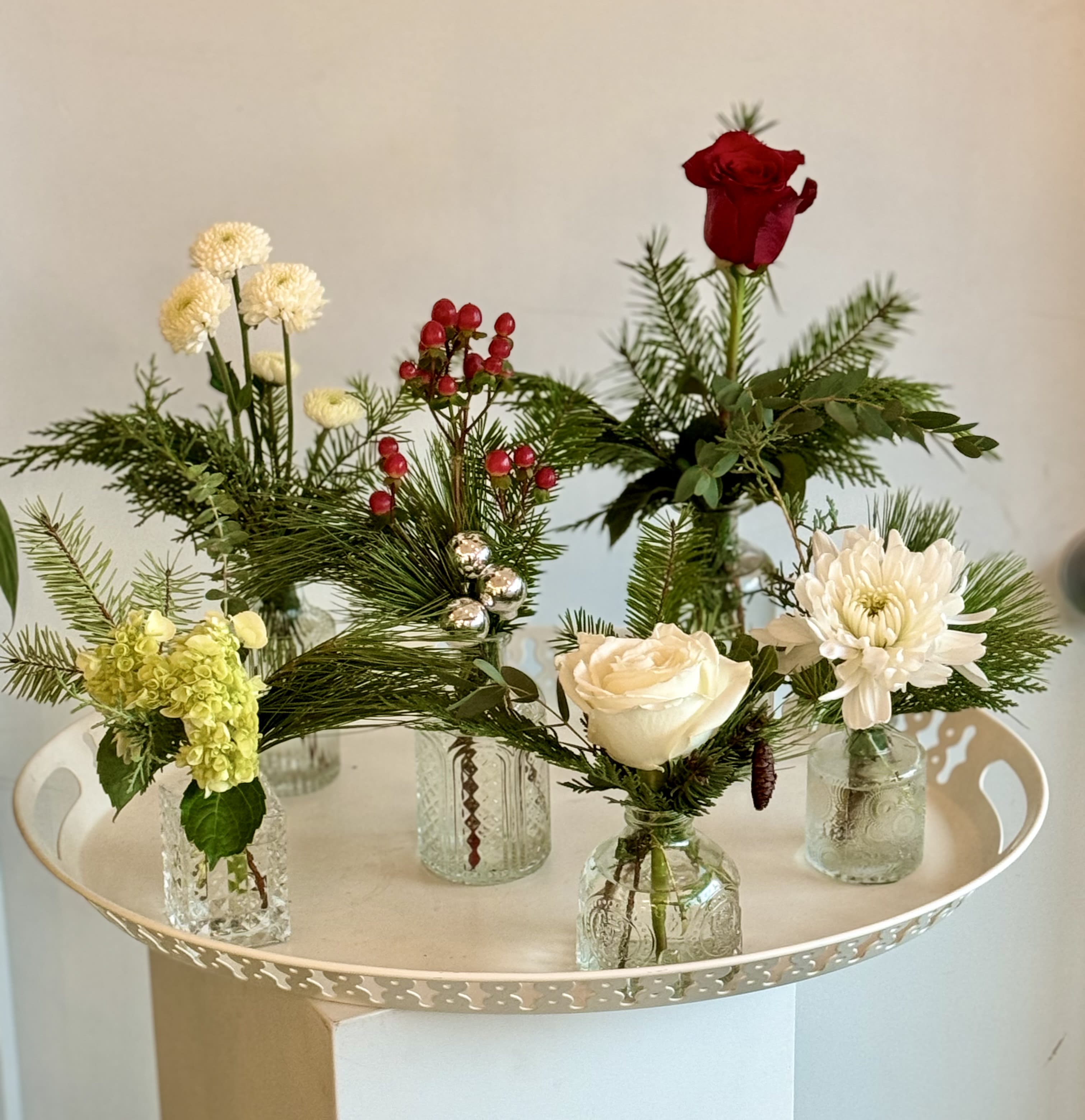 Bud vase blooms - These charming bud vases can be used as a centerpiece staggered down the center of a table or place them throughout your home.  They make great gifts to give to your guests as well.  Each vase differs slightly and adds the holiday spirit to everyone!  Please read our substitution policy.